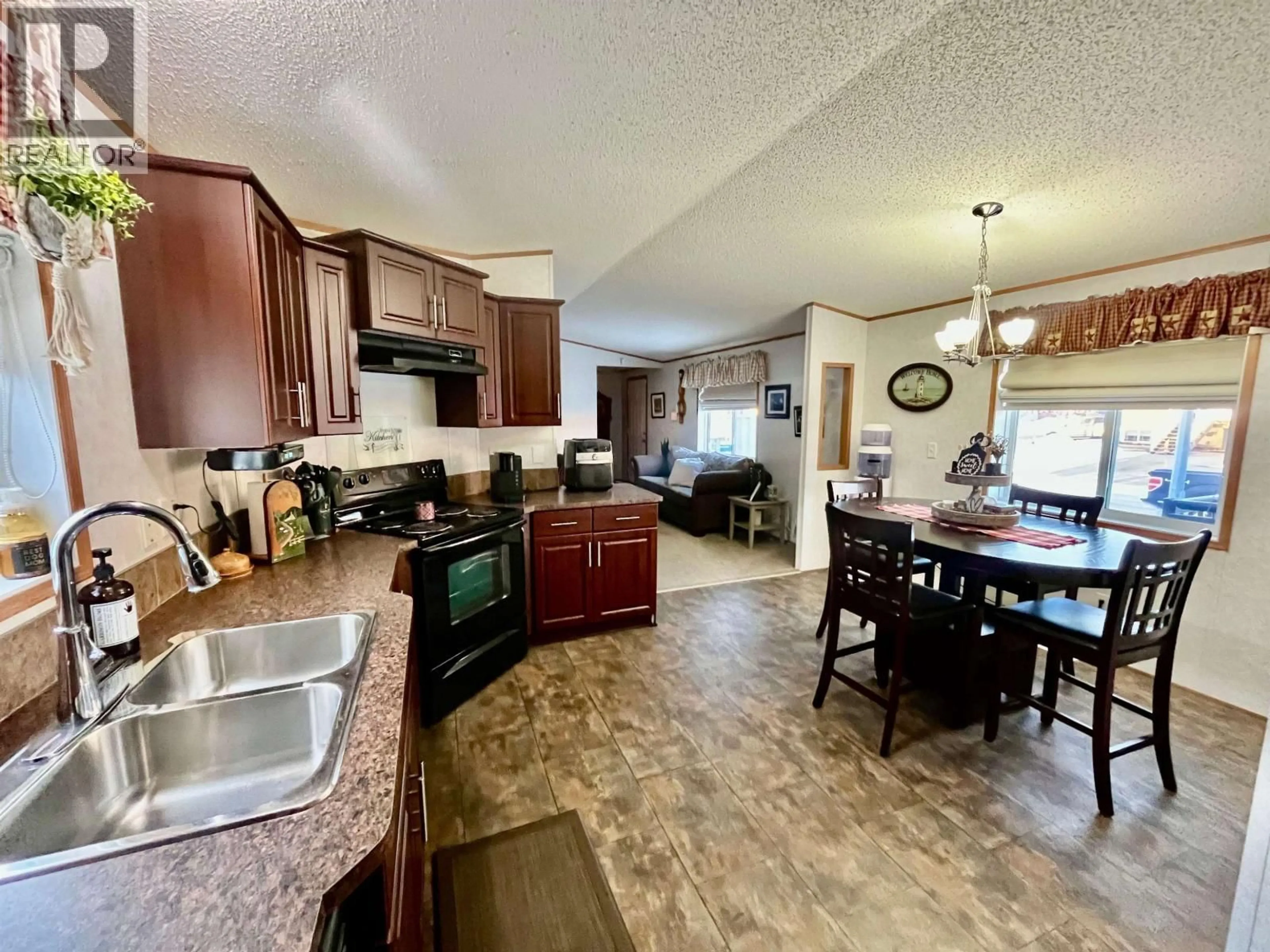 Open concept kitchen, ceramic/tile floor for 8112 85A AVENUE, Fort St. John British Columbia V1J0H7