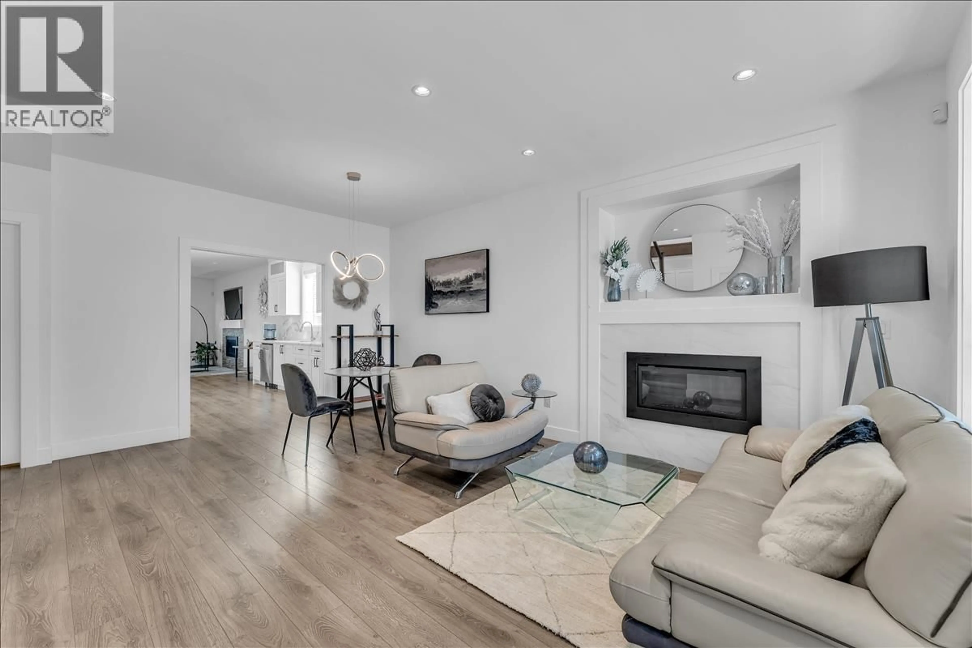 Living room with furniture, wood/laminate floor for 7430 CANADA WAY, Burnaby British Columbia V3N3J6