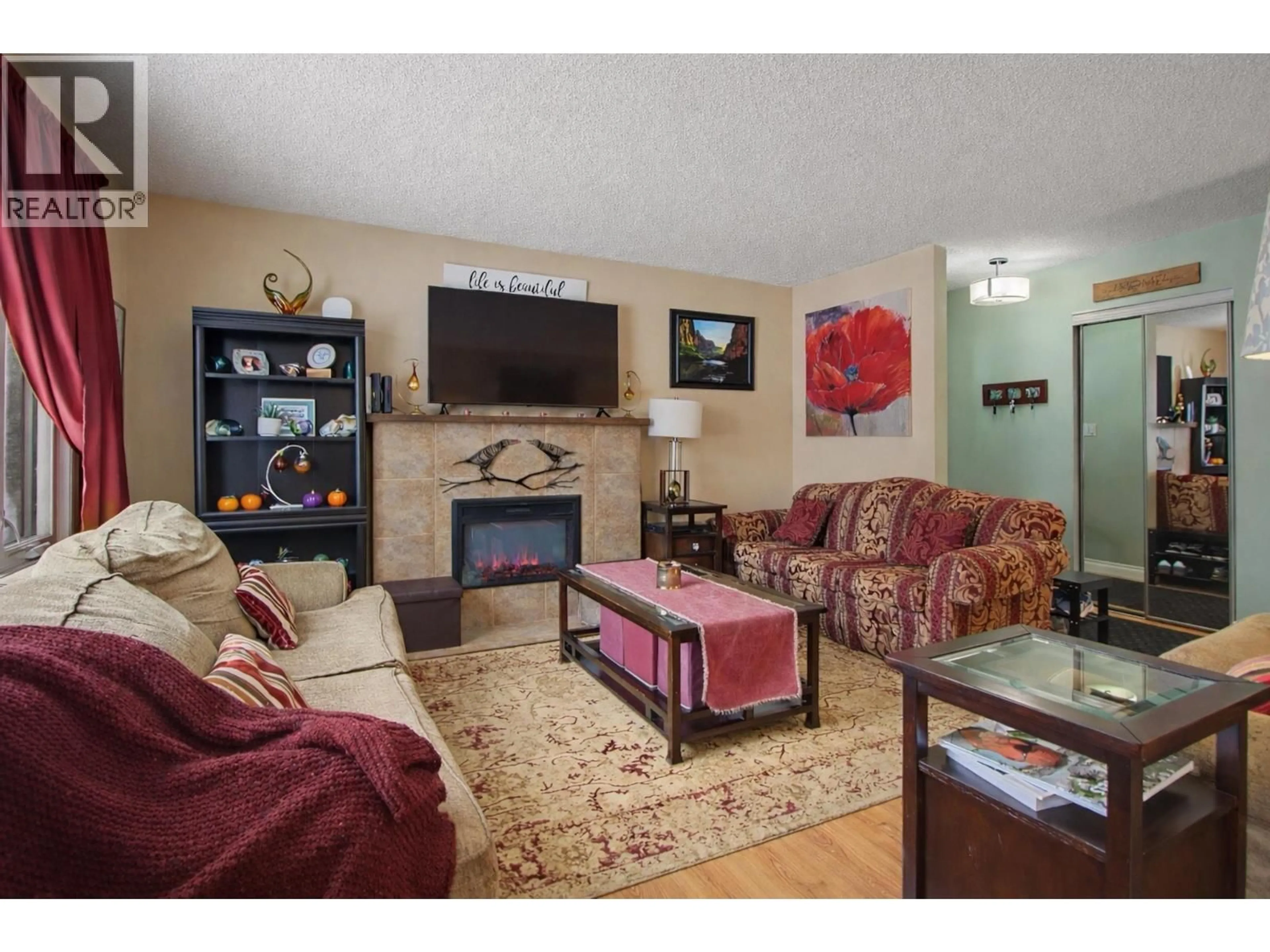 Living room with furniture, wood/laminate floor for 6869 FAIRMONT CRESCENT, Prince George British Columbia V2N2P7