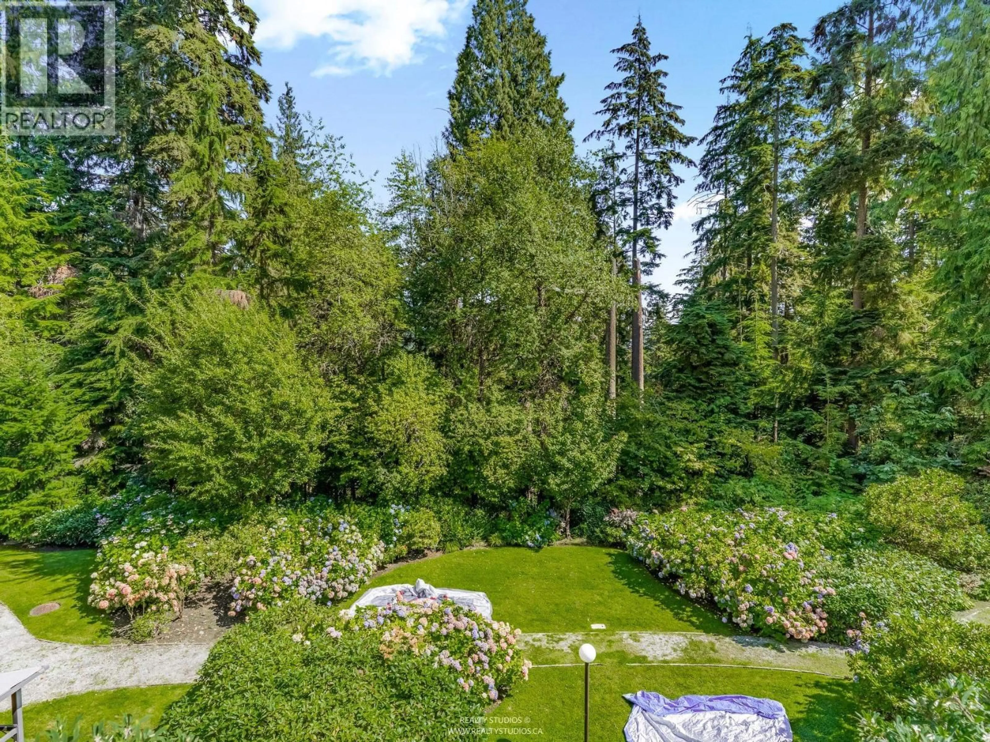 A pic from outside/outdoor area/front of a property/back of a property/a pic from drone, forest/trees view for 305 - 1500 OSTLER COURT, North Vancouver British Columbia V7G2S2