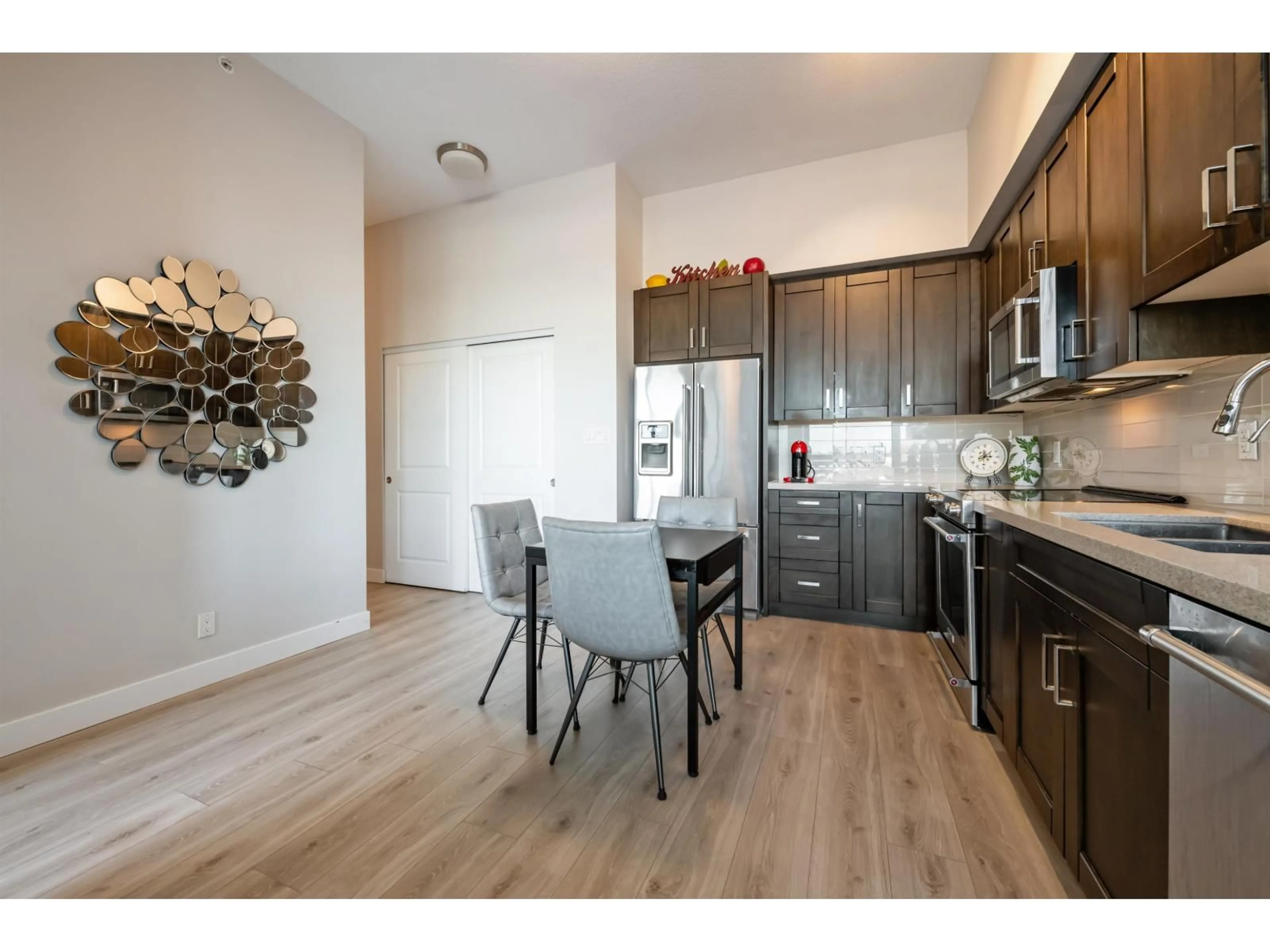 Open concept kitchen, wood/laminate floor for 506 - 11967 80 AVENUE, Delta British Columbia V4C0E2