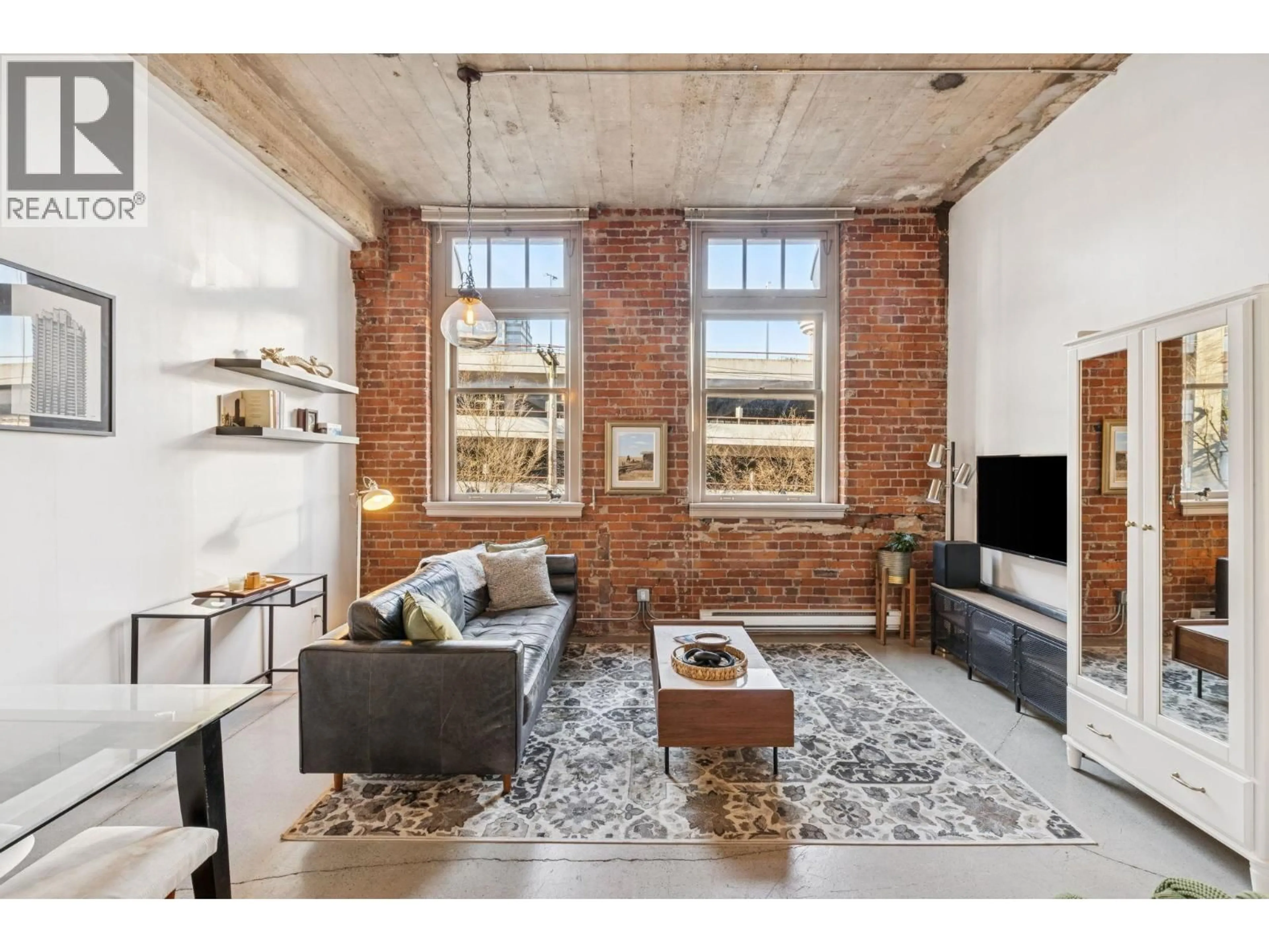 Living room with furniture, cement floor for 206 - 546 BEATTY STREET, Vancouver British Columbia V6B2L3