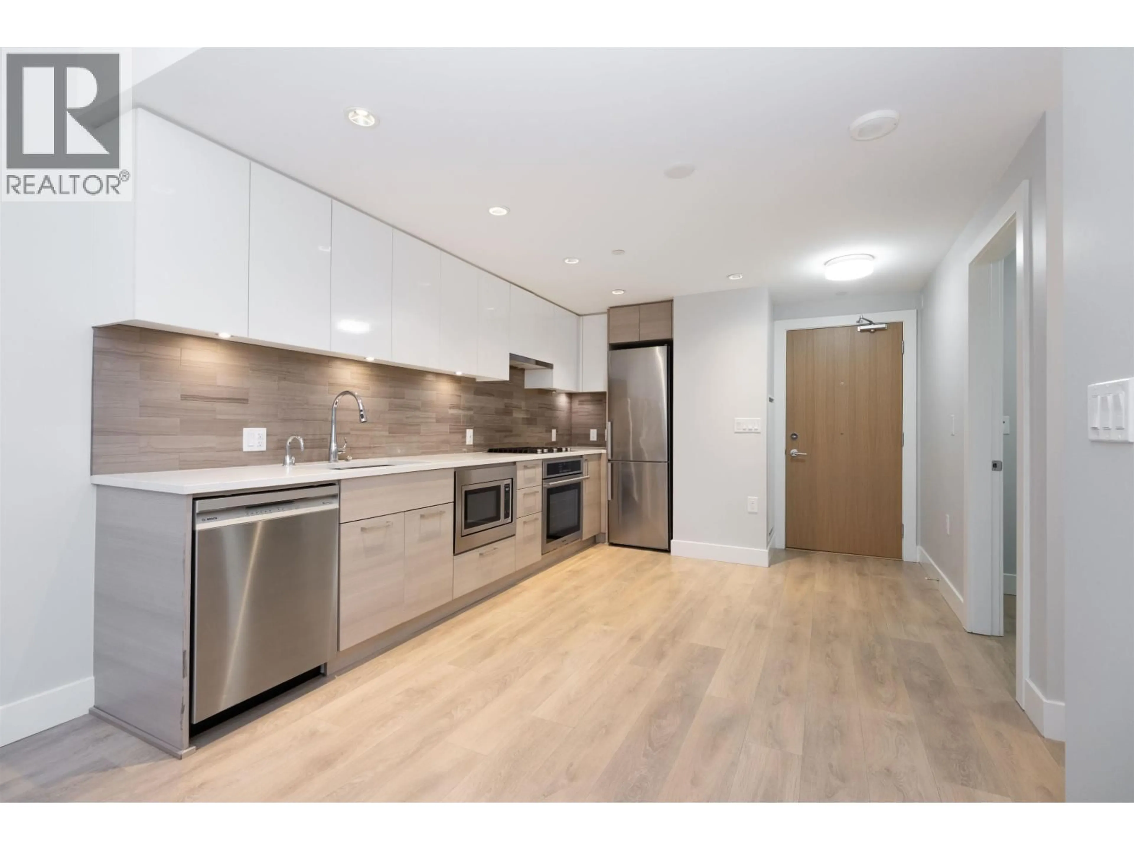 Open concept kitchen, wood/laminate floor for 201 - 3451 SAWMILL CRESCENT, Vancouver British Columbia V5S0H3