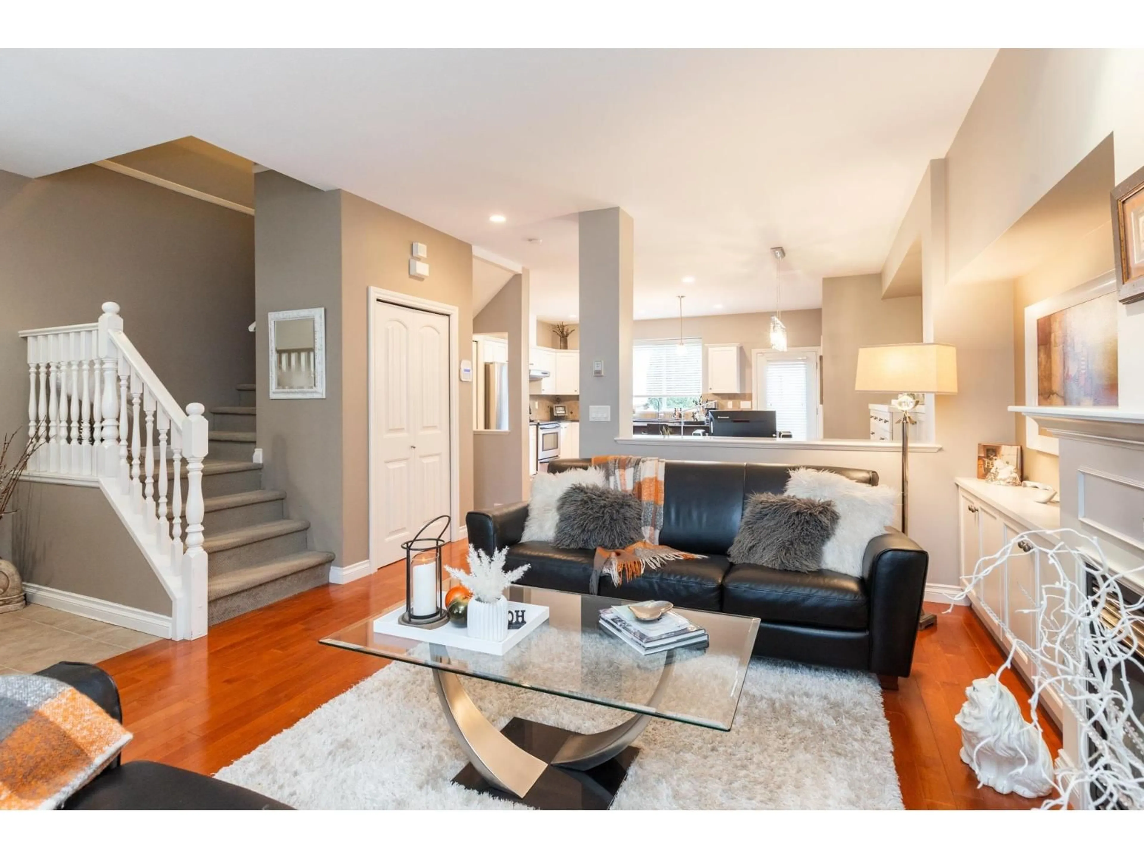 Living room with furniture, wood/laminate floor for 7016 - 179A SURREY STREET, Surrey British Columbia V3S7S4