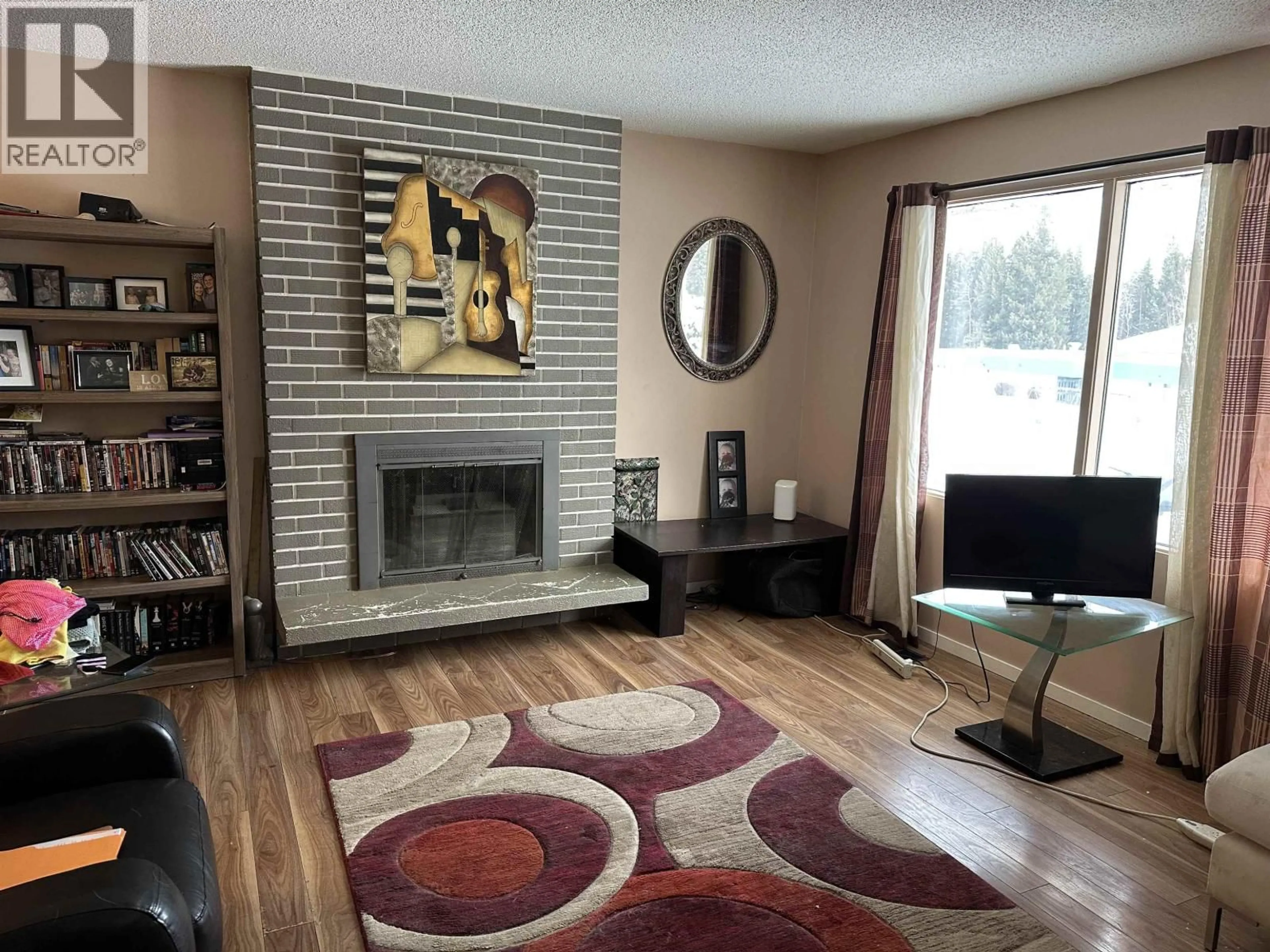 Living room with furniture, wood/laminate floor for 5423 SIMON FRASER AVENUE, Prince George British Columbia V2N2C1