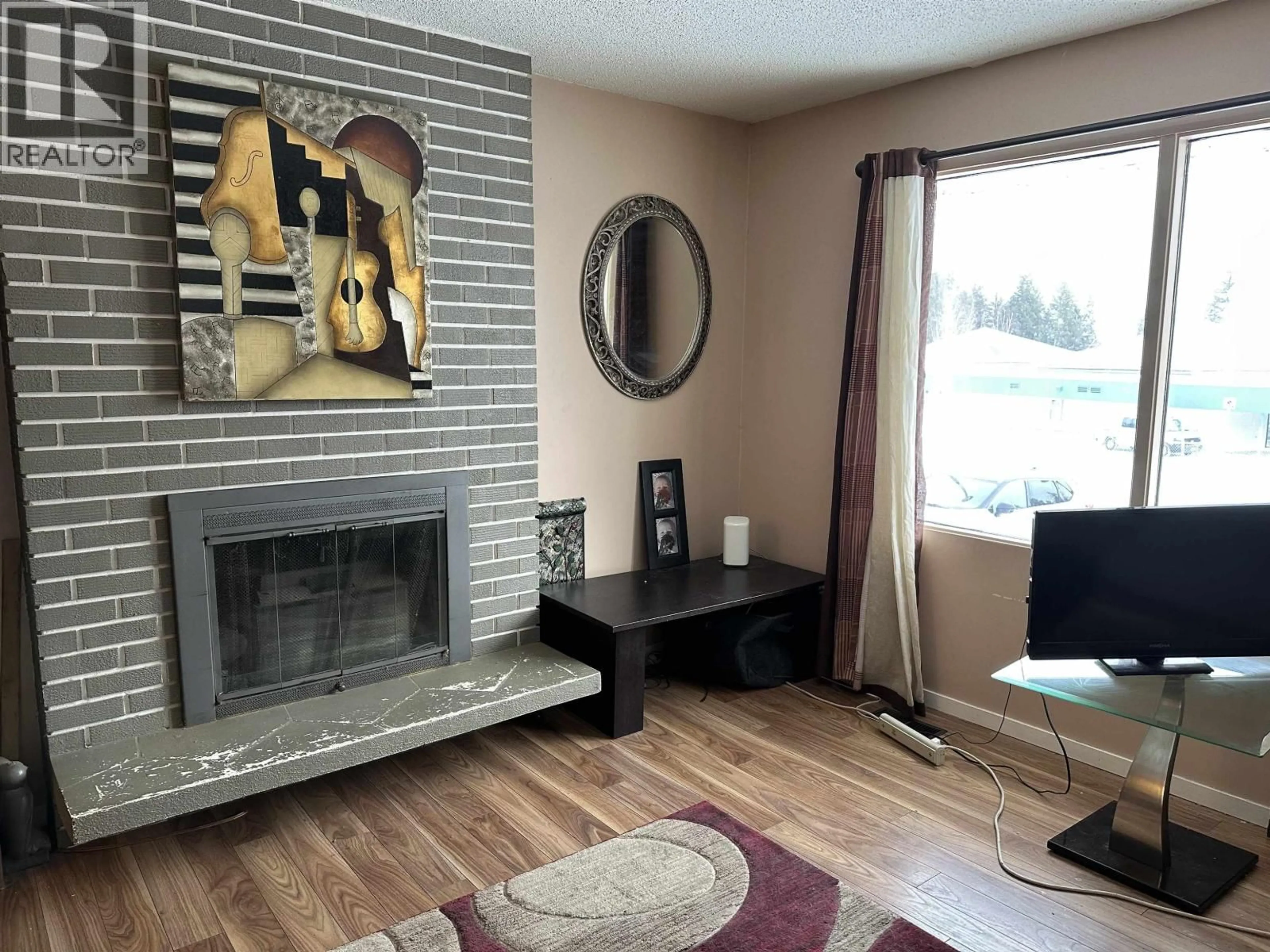 Living room with furniture, wood/laminate floor for 5423 SIMON FRASER AVENUE, Prince George British Columbia V2N2C1