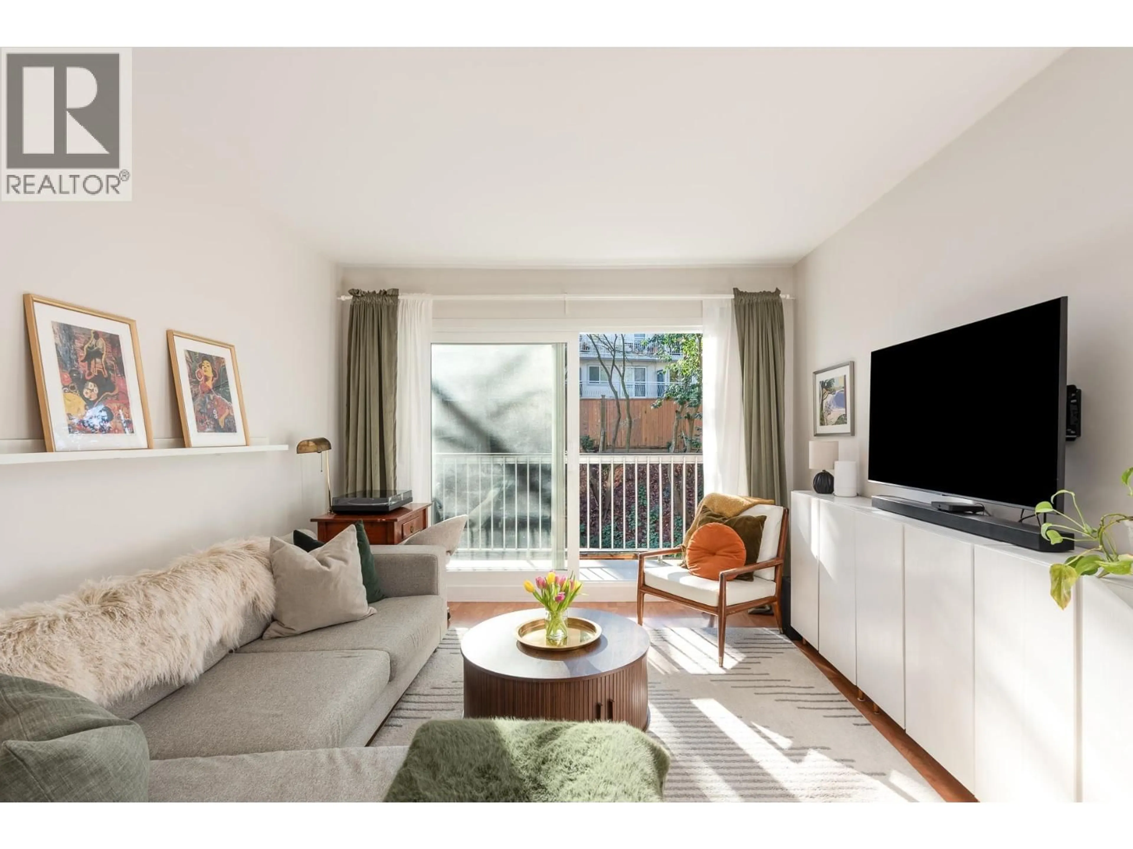 Living room with furniture, wood/laminate floor for 809 - 756 GREAT NORTHERN WAY, Vancouver British Columbia V5T1E4