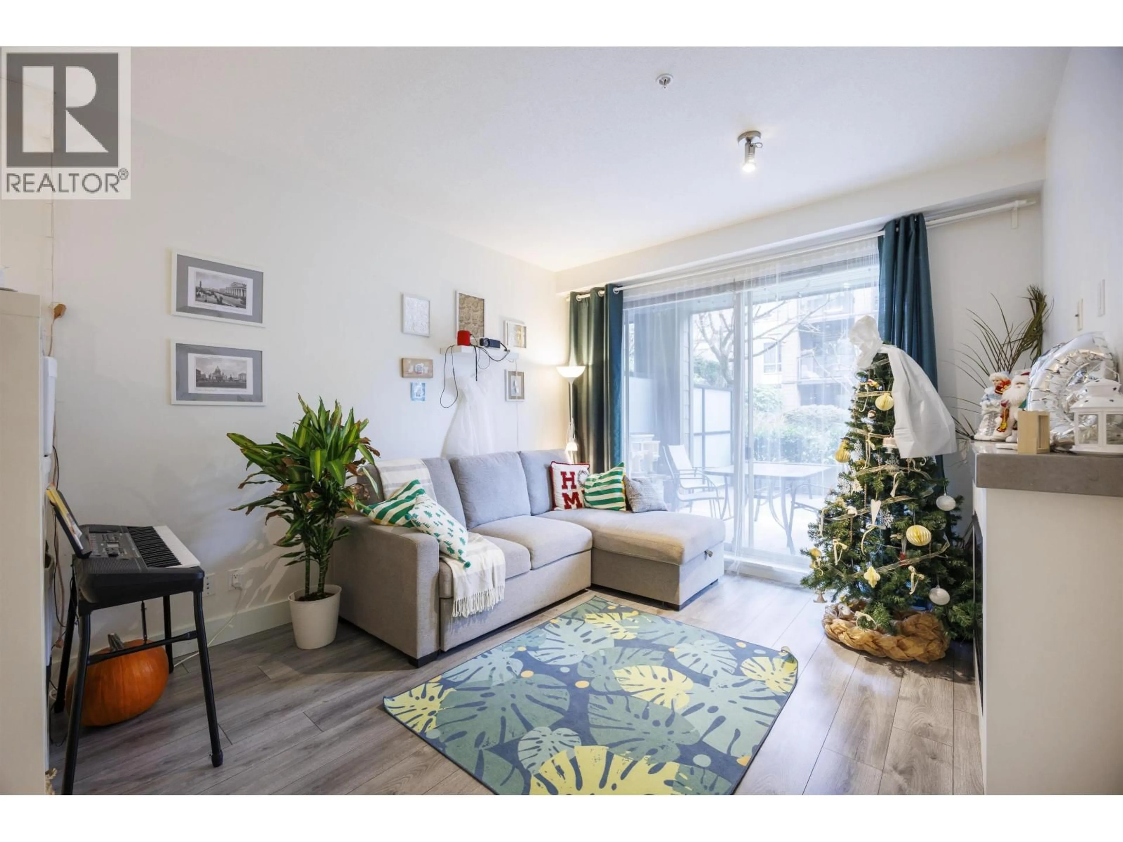 Living room with furniture, wood/laminate floor for 210 - 7478 BYRNE PARK WALK, Burnaby British Columbia V3N0B5