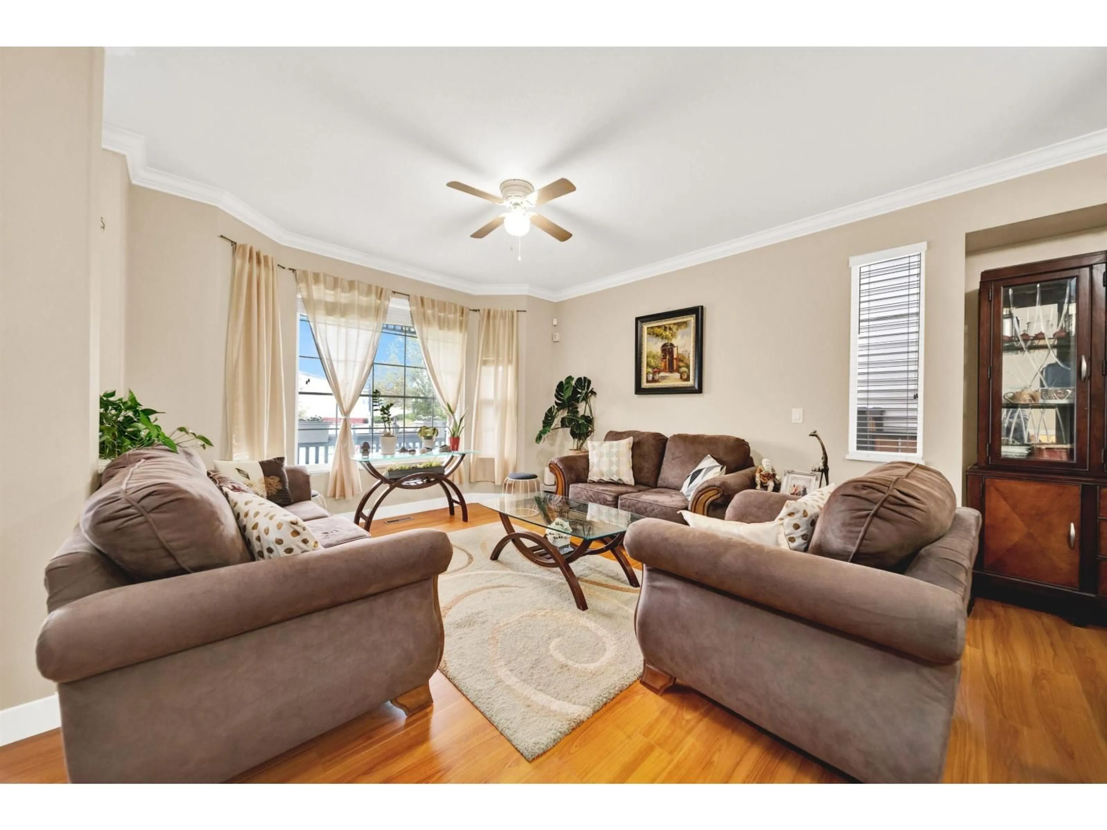 Living room with furniture, wood/laminate floor for 18556 65 AVENUE, Surrey British Columbia V3S8S9