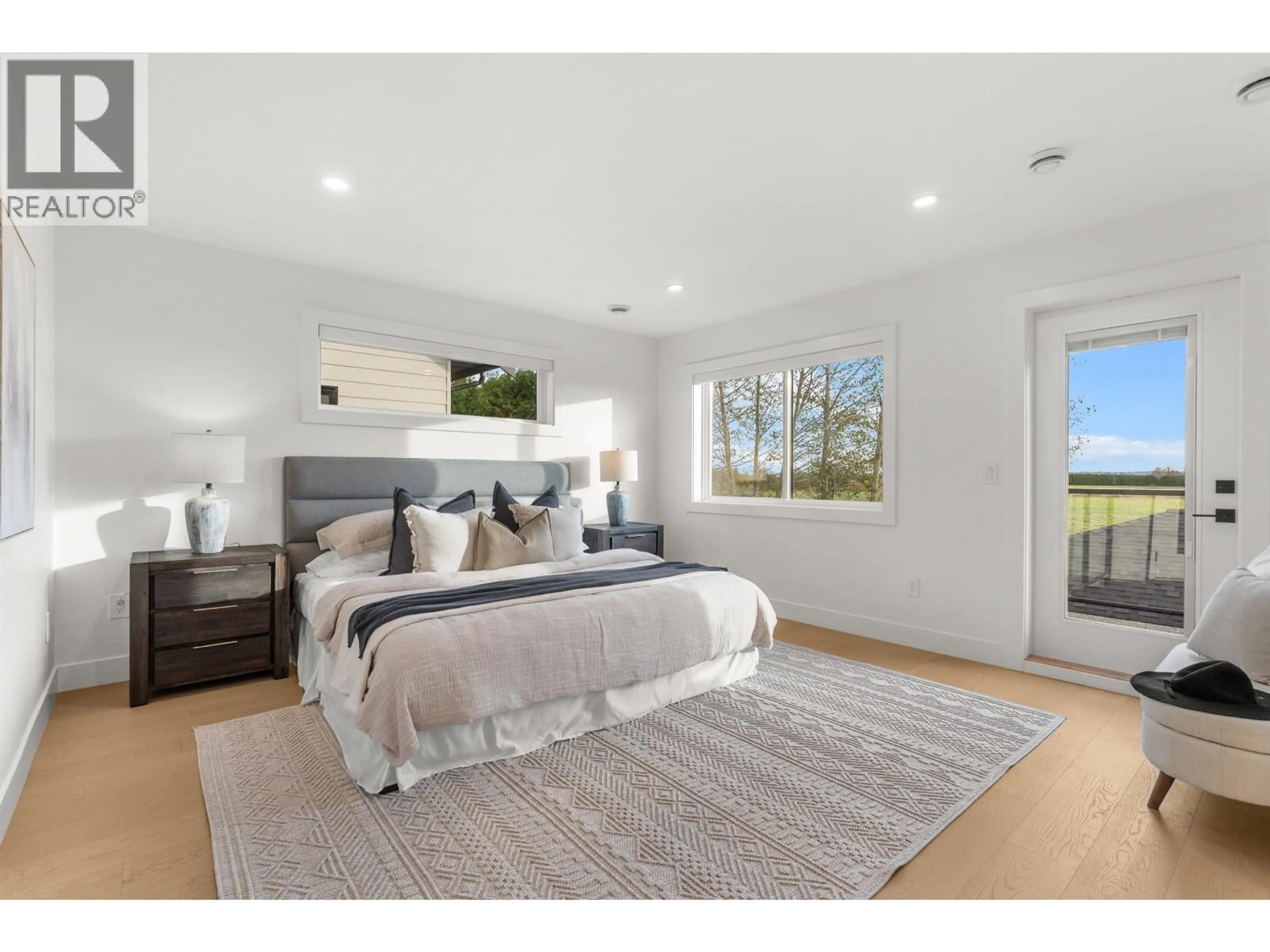 Bedroom with bed, wood/laminate floor for 4810 42A AVENUE, Ladner British Columbia V4K1A1