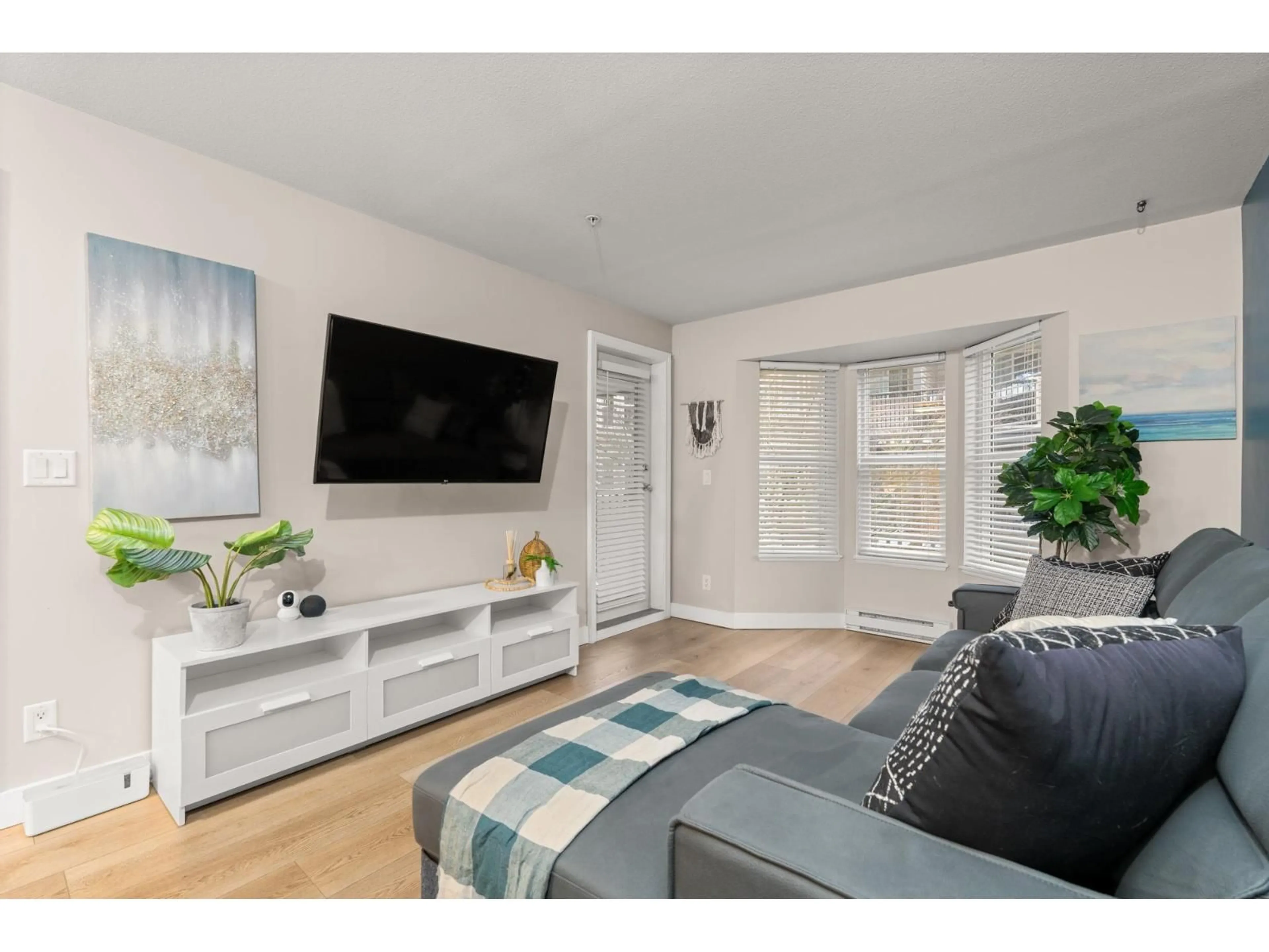 Living room with furniture, wood/laminate floor for 204 - 5454 198 STREET, Langley British Columbia V3A1G2