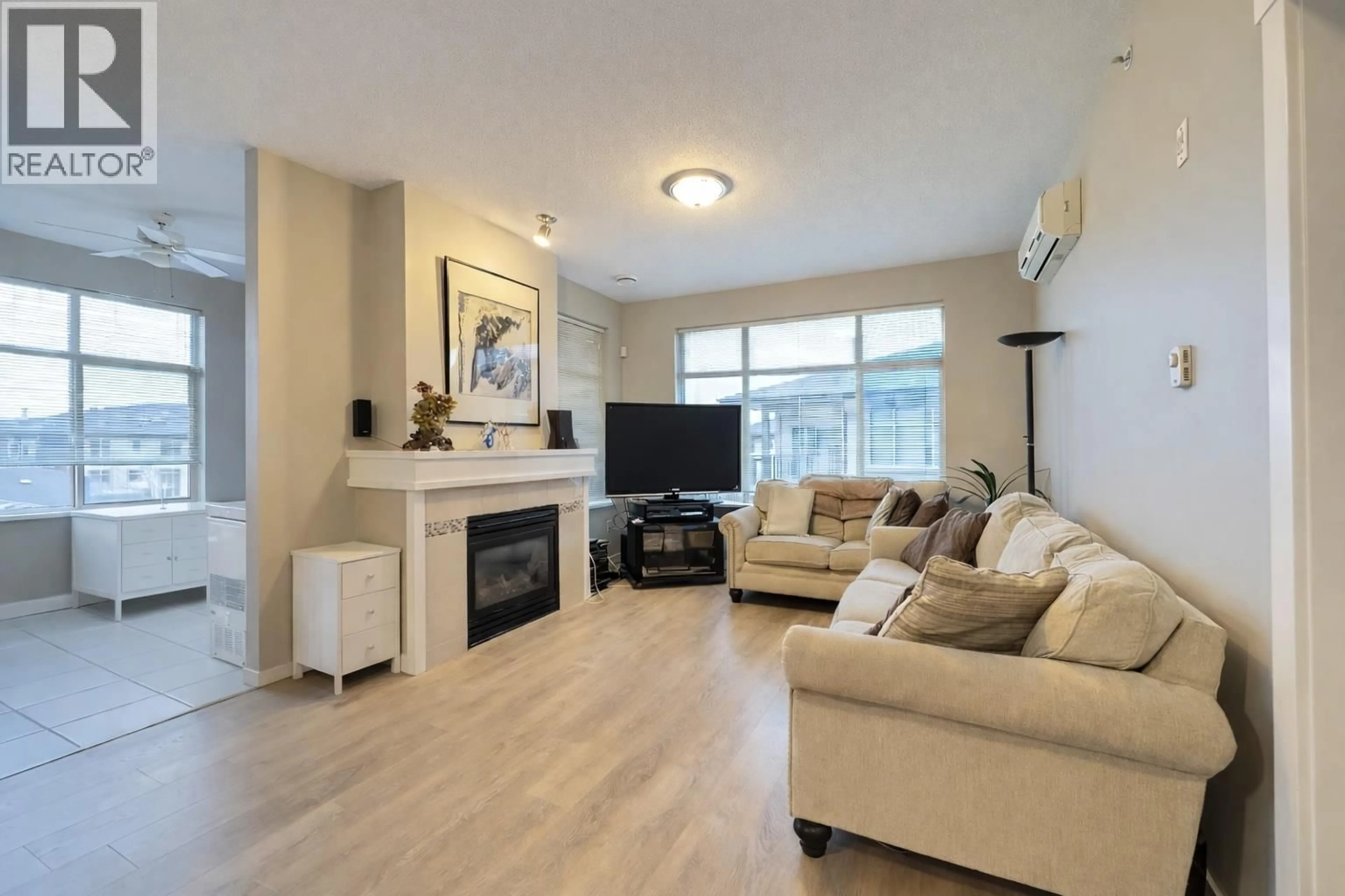 Living room with furniture, wood/laminate floor for 410 - 9288 ODLIN ROAD, Richmond British Columbia V6X0C3