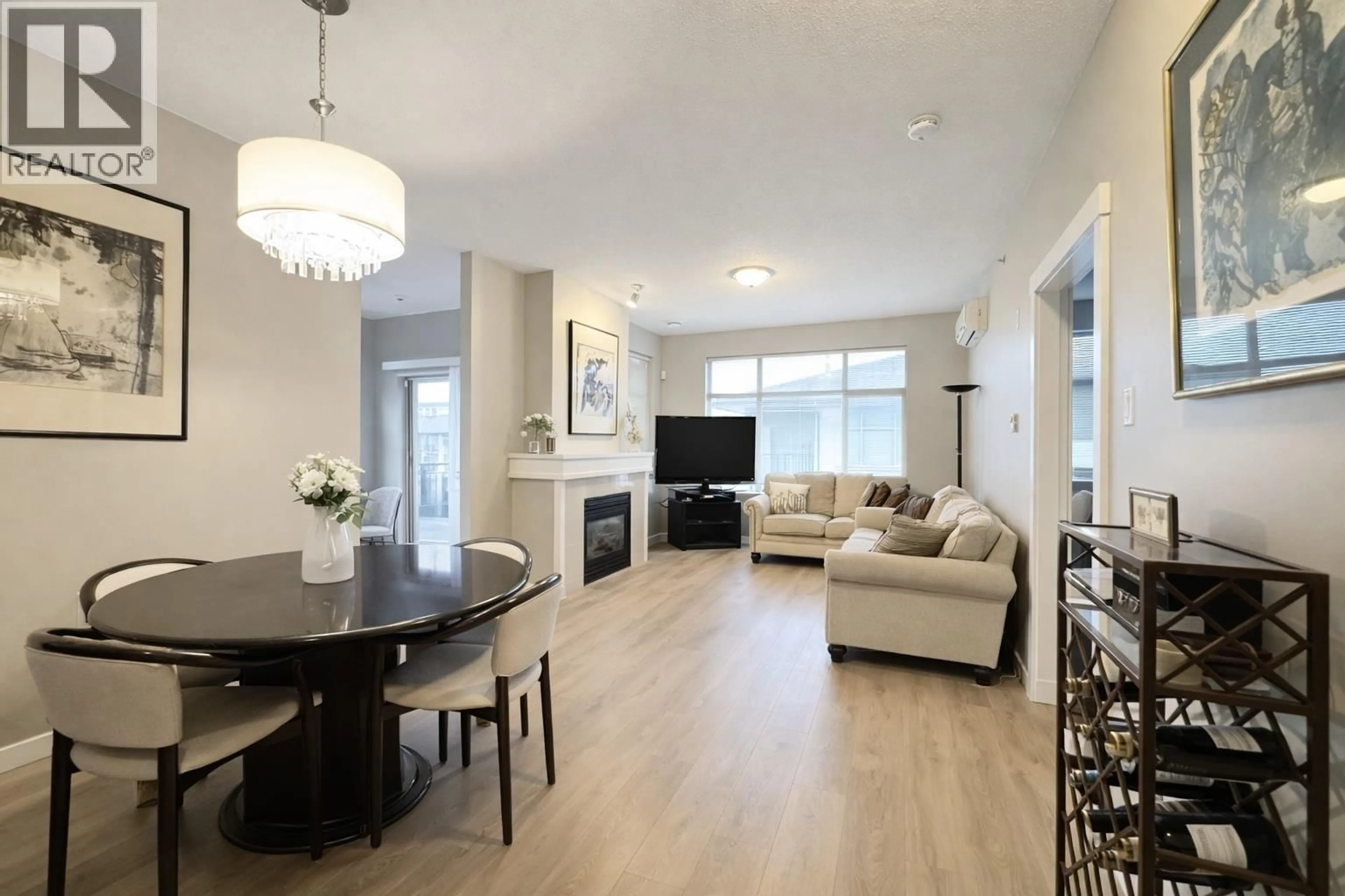 Living room with furniture, wood/laminate floor for 410 - 9288 ODLIN ROAD, Richmond British Columbia V6X0C3