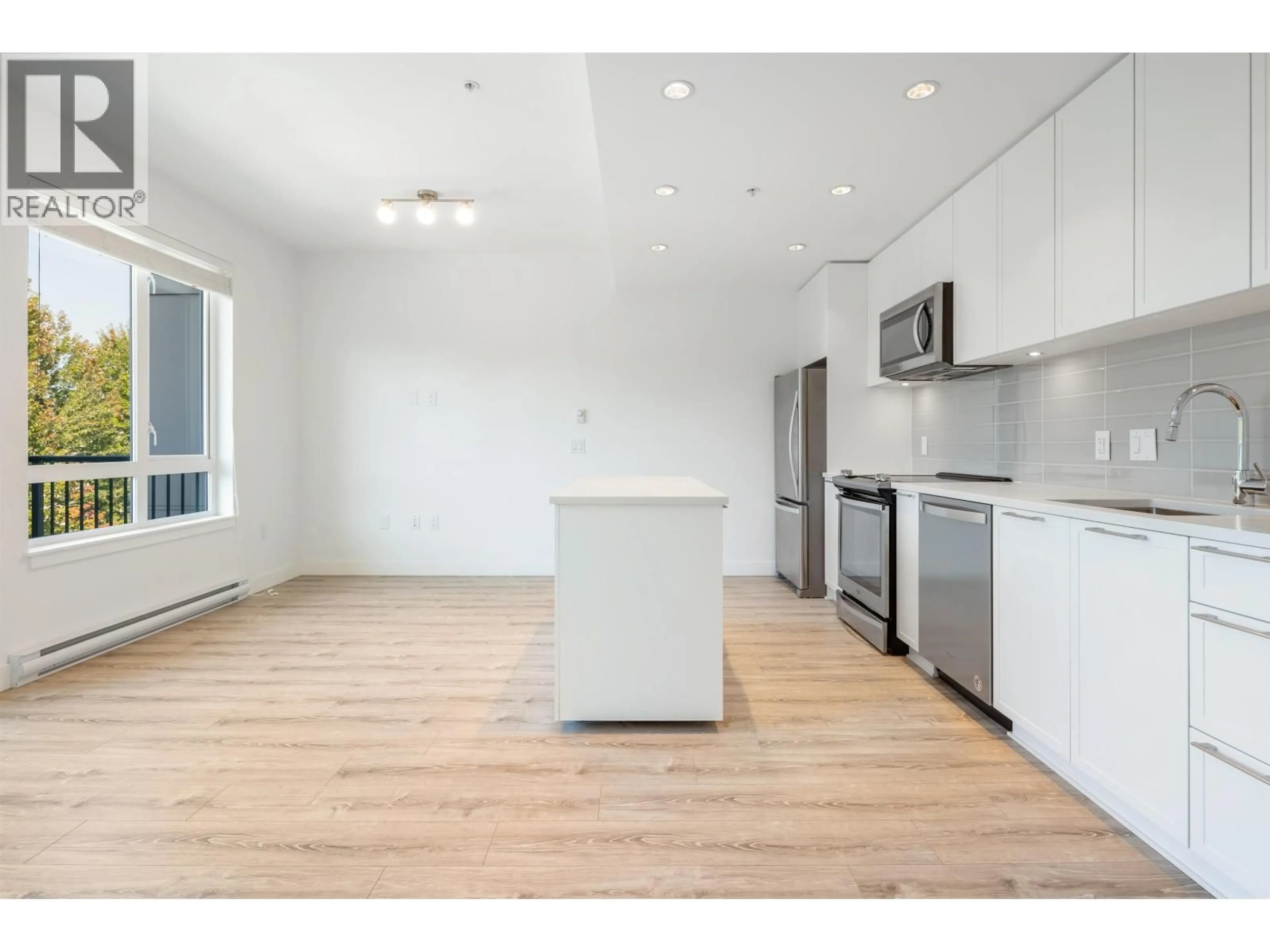 Open concept kitchen, wood/laminate floor for 407 - 2382 ATKINS AVENUE, Port Coquitlam British Columbia V3C0G7