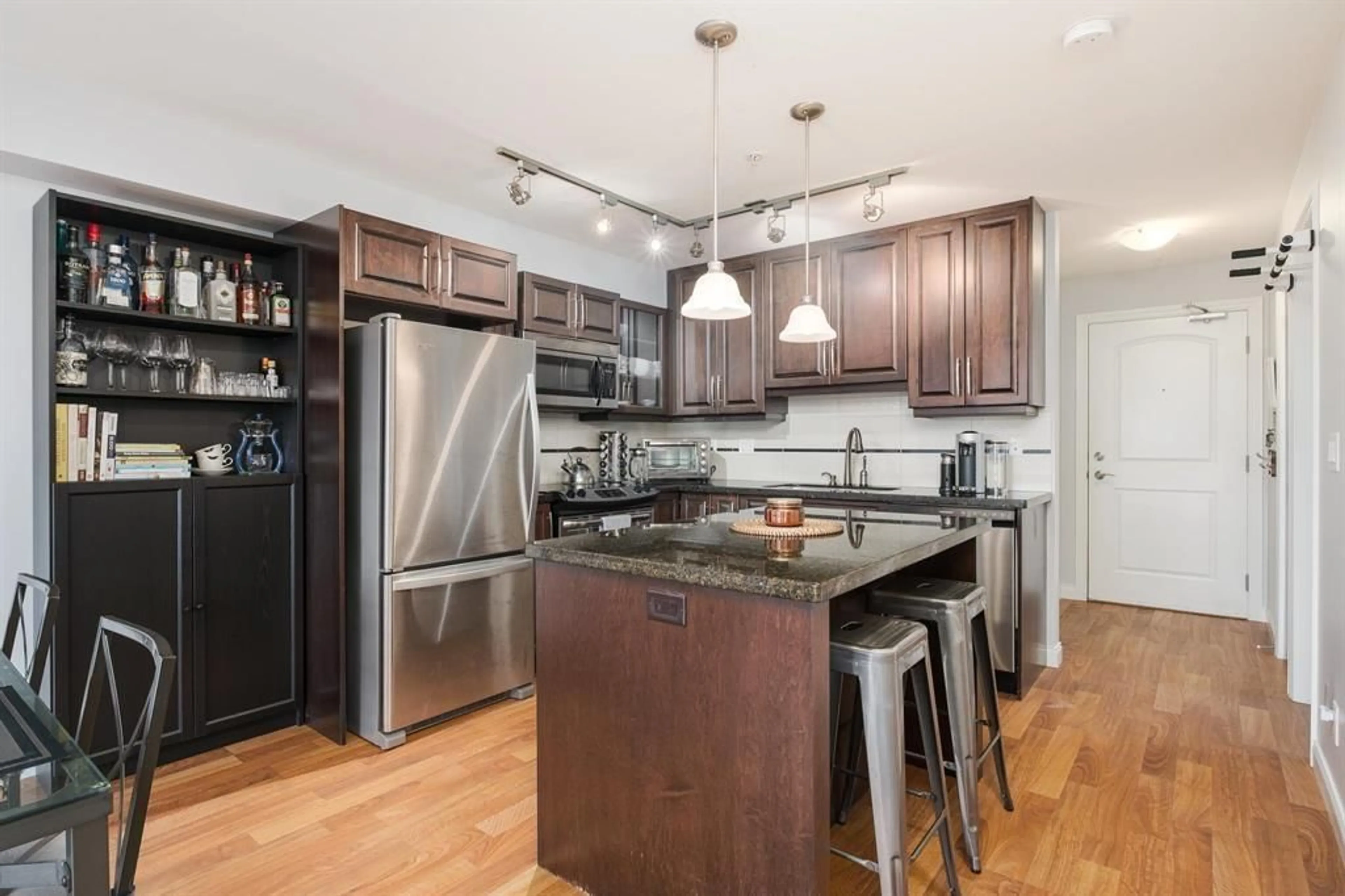 Open concept kitchen, wood/laminate floor for 312 - 19939 55A AVENUE, Langley British Columbia V3A3X4