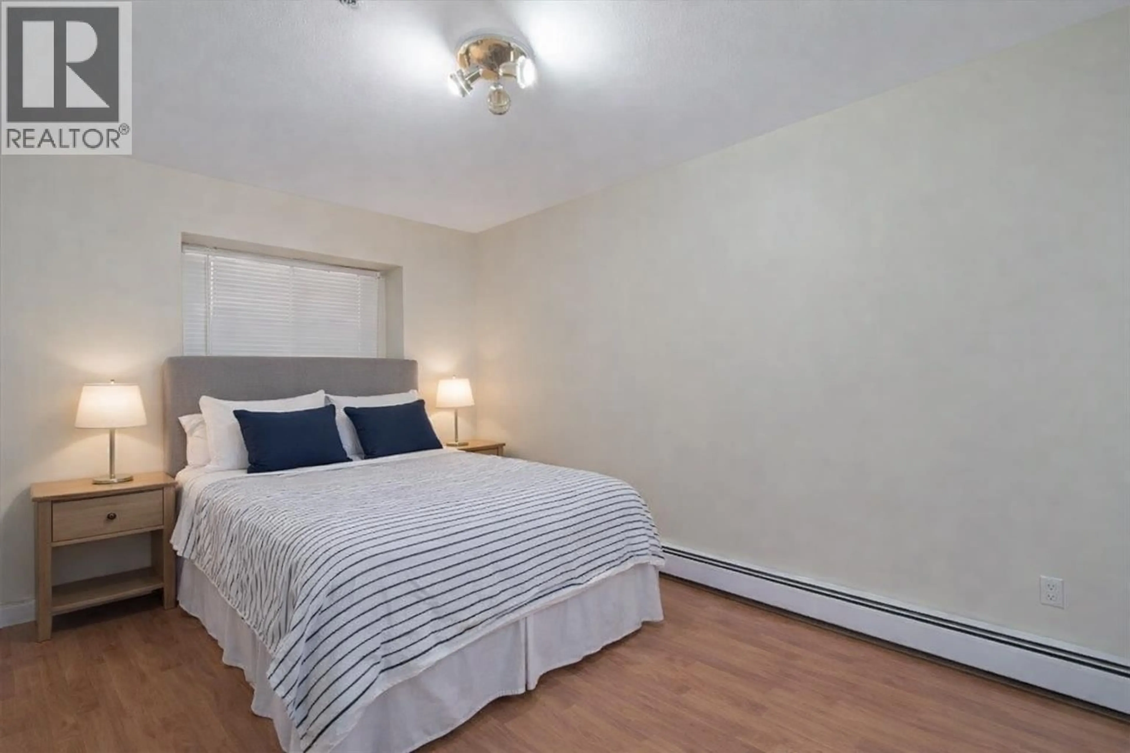 Bedroom with bed, wood/laminate floor for 7138 FRASER STREET, Vancouver British Columbia V5X3V7
