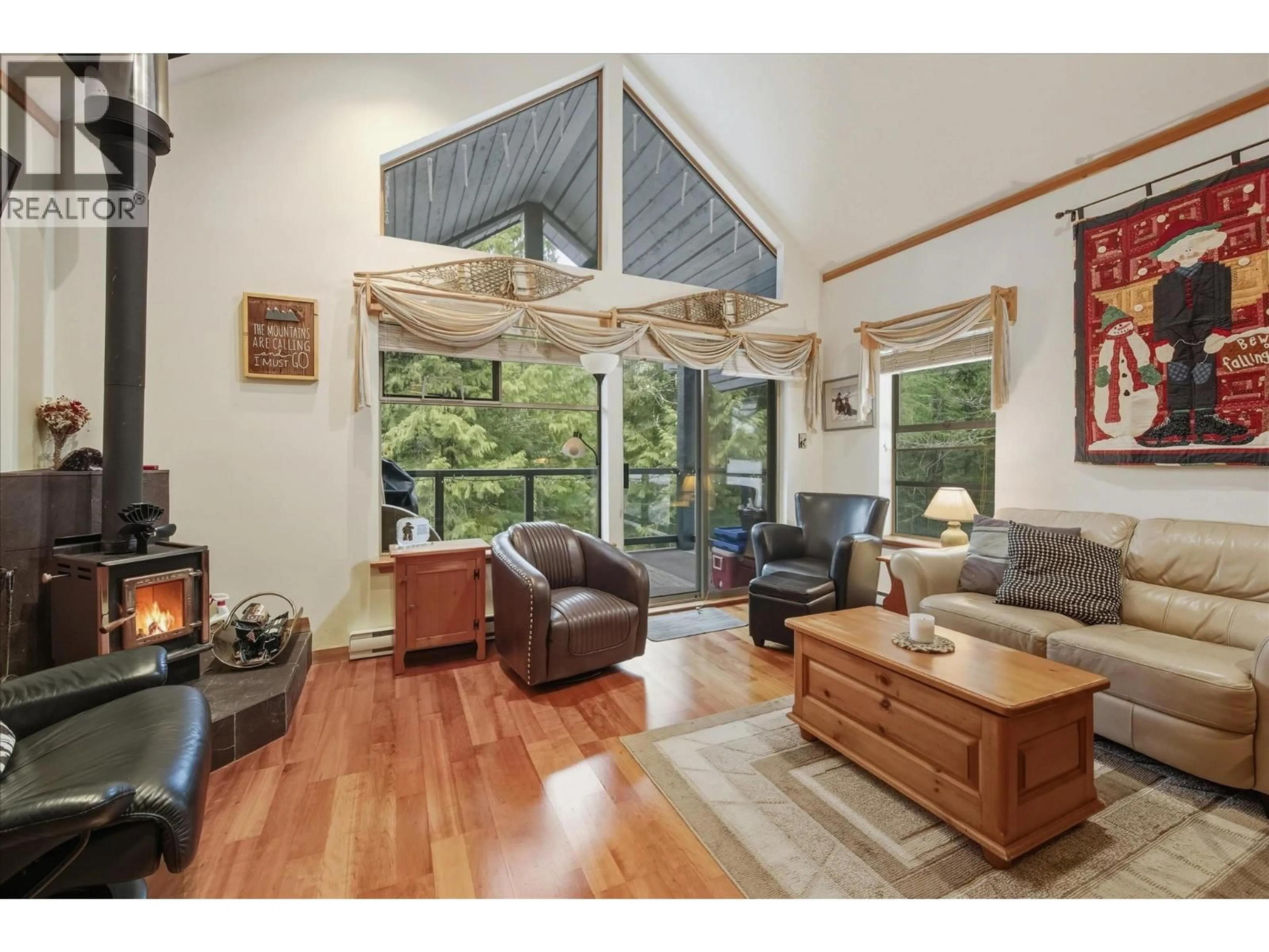 Living room with furniture, wood/laminate floor for 202 - 3050 HILLCREST DRIVE, Whistler British Columbia V8E0T8