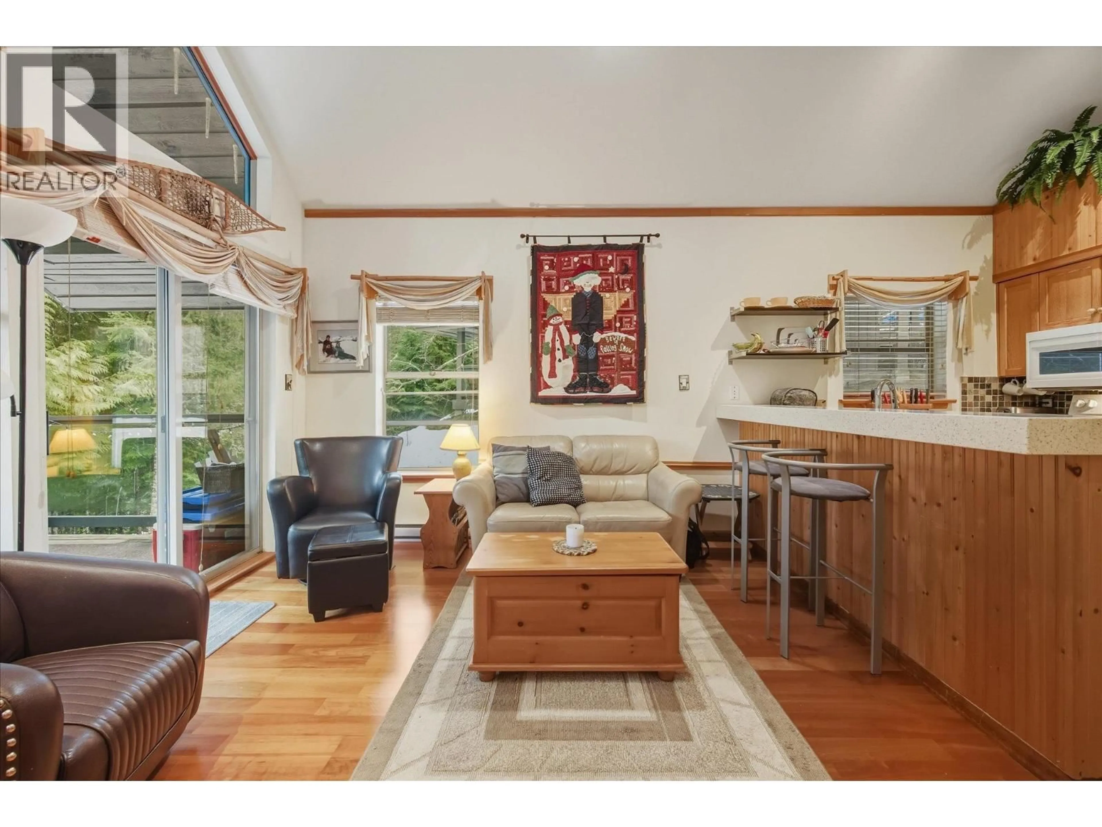 Living room with furniture, wood/laminate floor for 202 - 3050 HILLCREST DRIVE, Whistler British Columbia V8E0T8