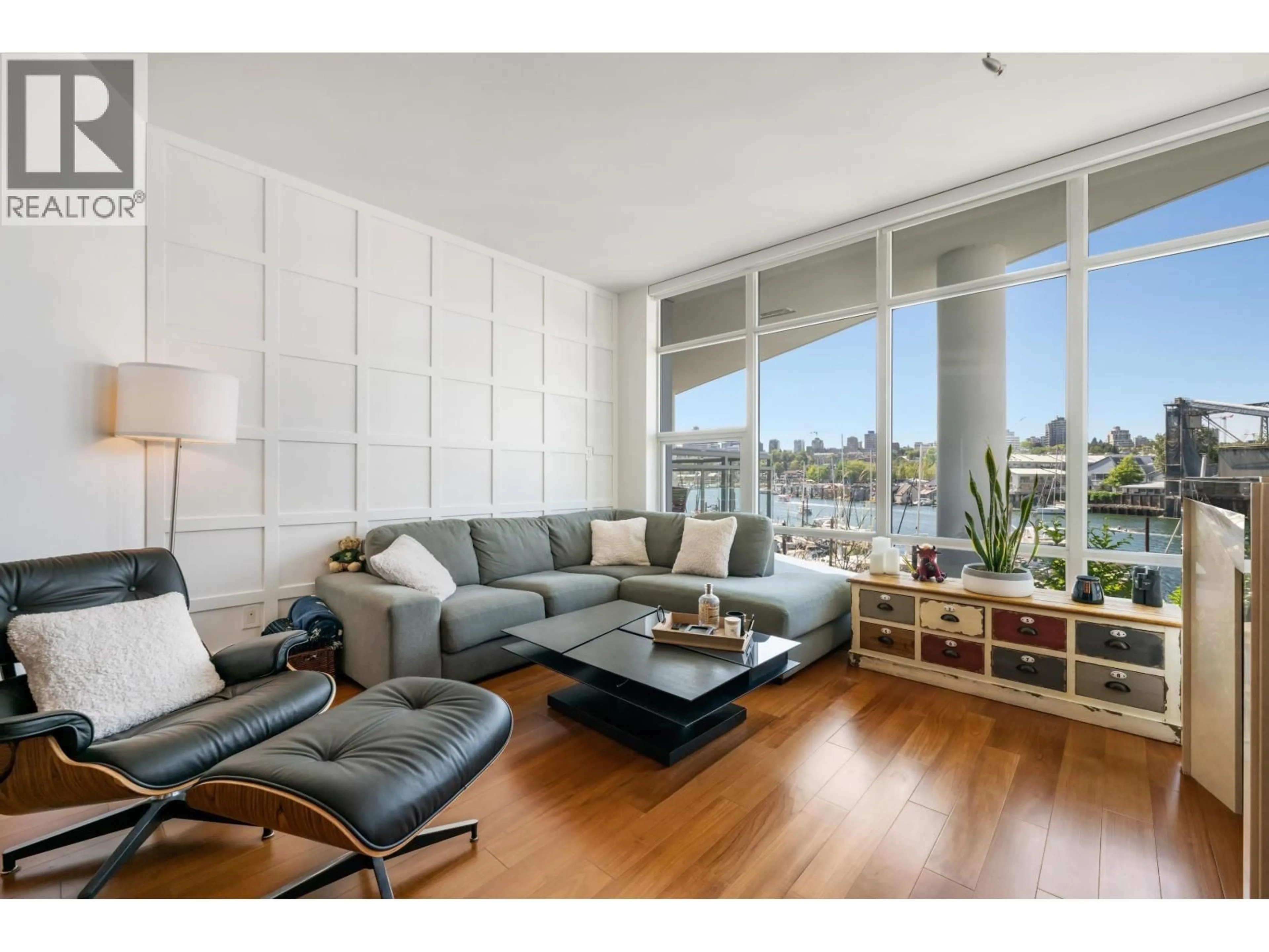 Living room with furniture, wood/laminate floor for 203 - 628 KINGHORNE MEWS, Vancouver British Columbia V6Z3H6