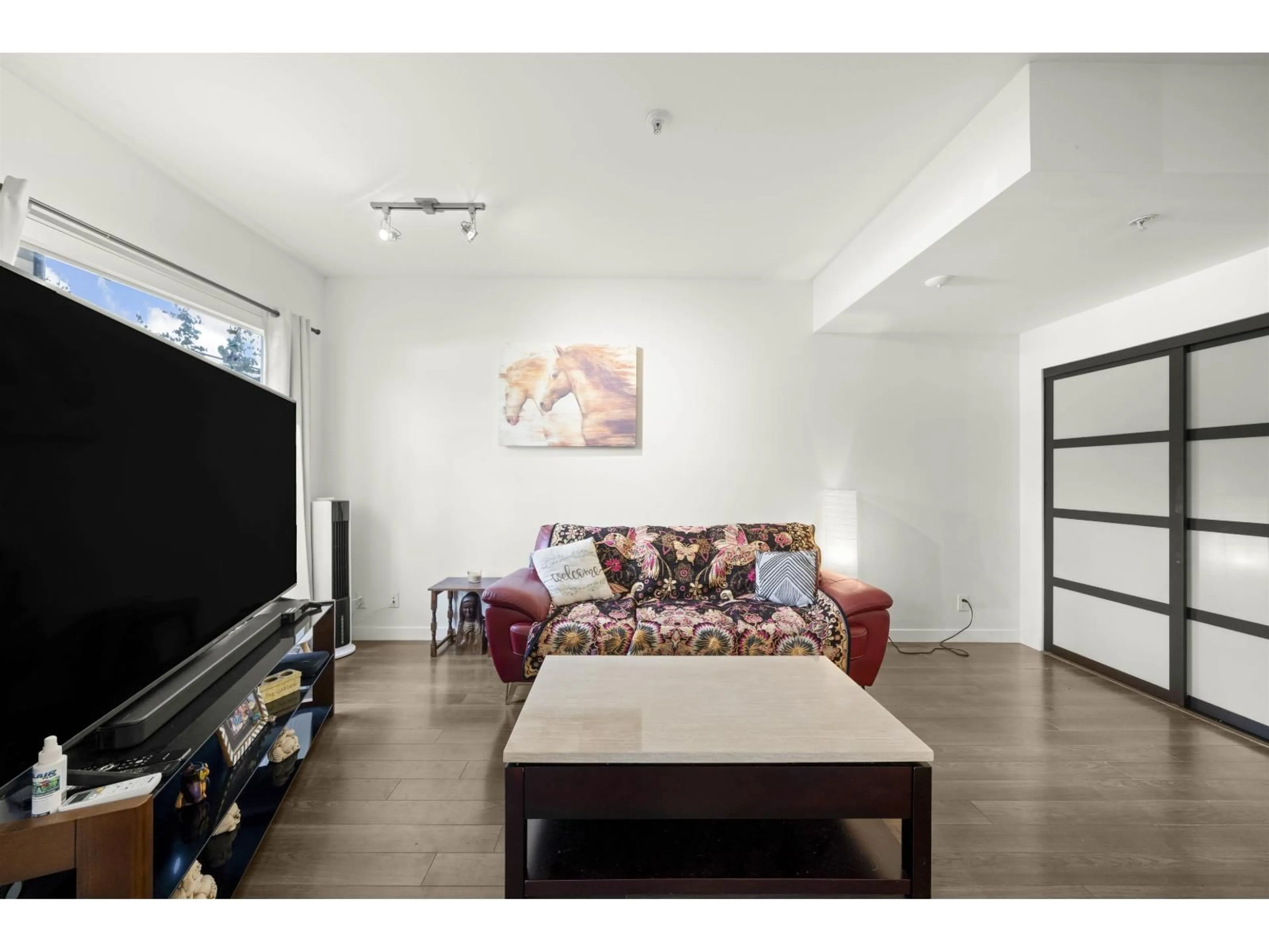 Living room with furniture, wood/laminate floor for 125 - 13228 OLD YALE ROAD, Surrey British Columbia V3T0K3