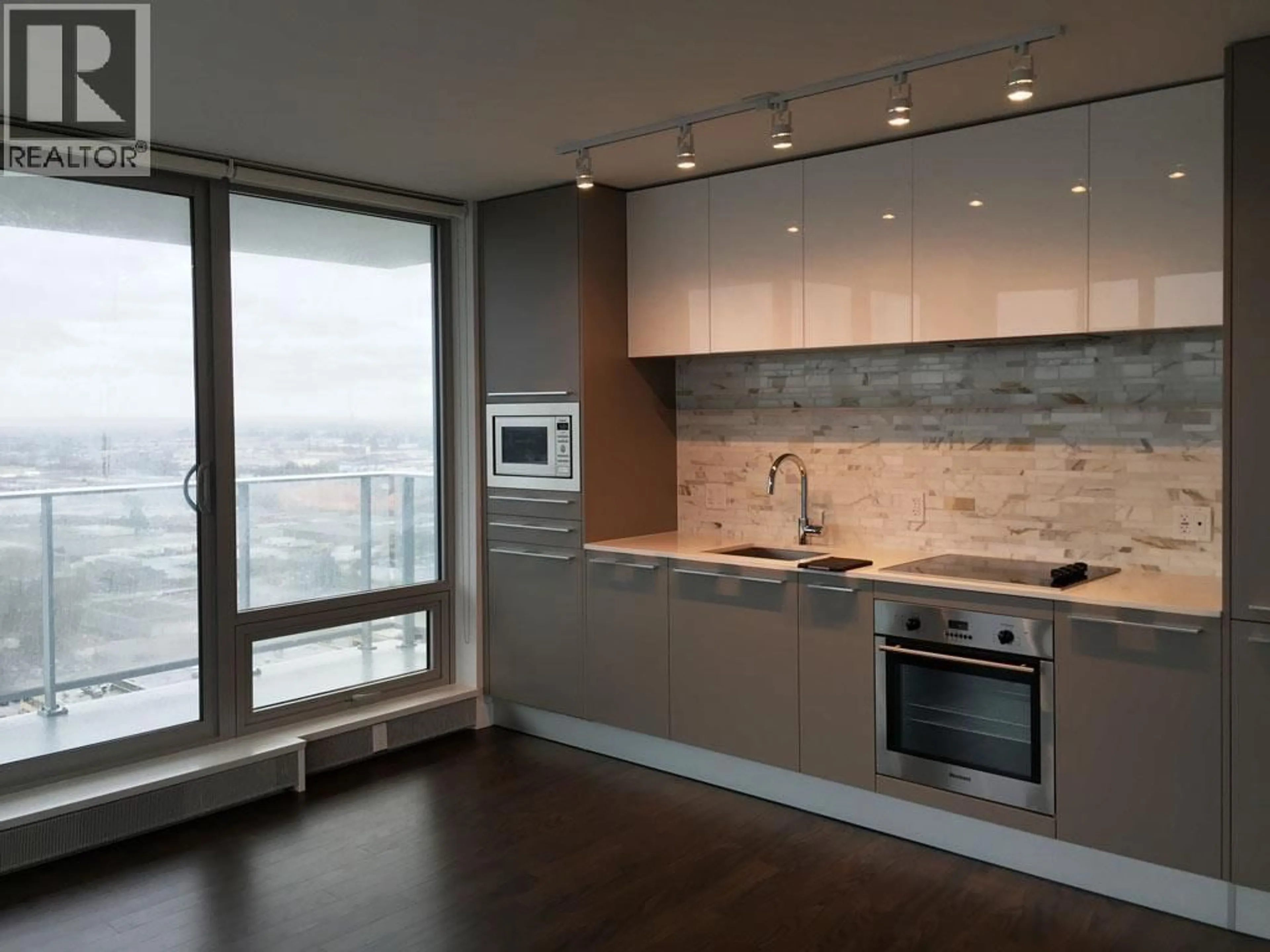 Open concept kitchen, wood/laminate floor for 2504 - 8131 NUNAVUT LANE, Vancouver British Columbia V5X0E2