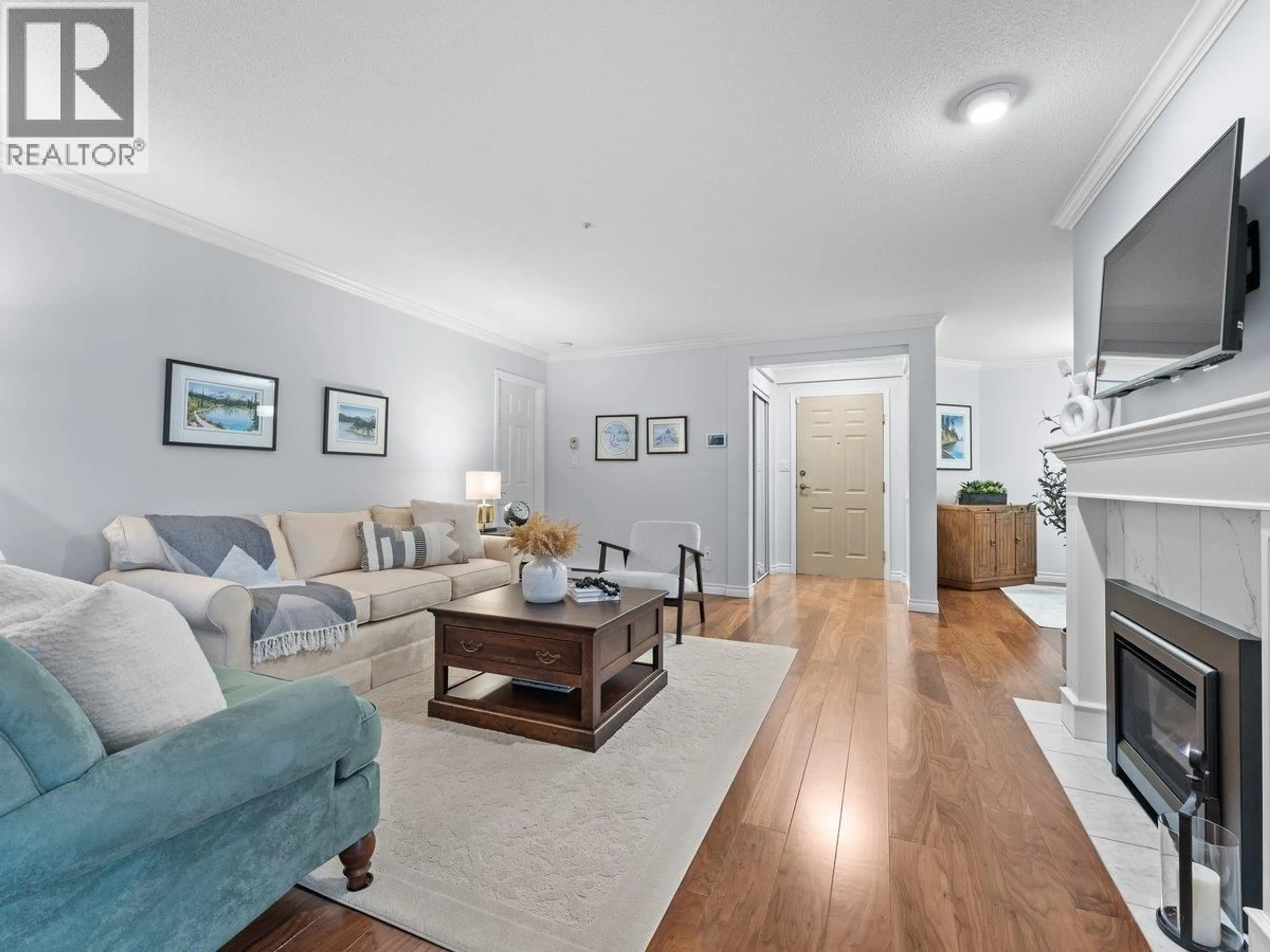 Living room with furniture, wood/laminate floor for 107 - 3690 BANFF COURT, North Vancouver British Columbia V7H2Y7