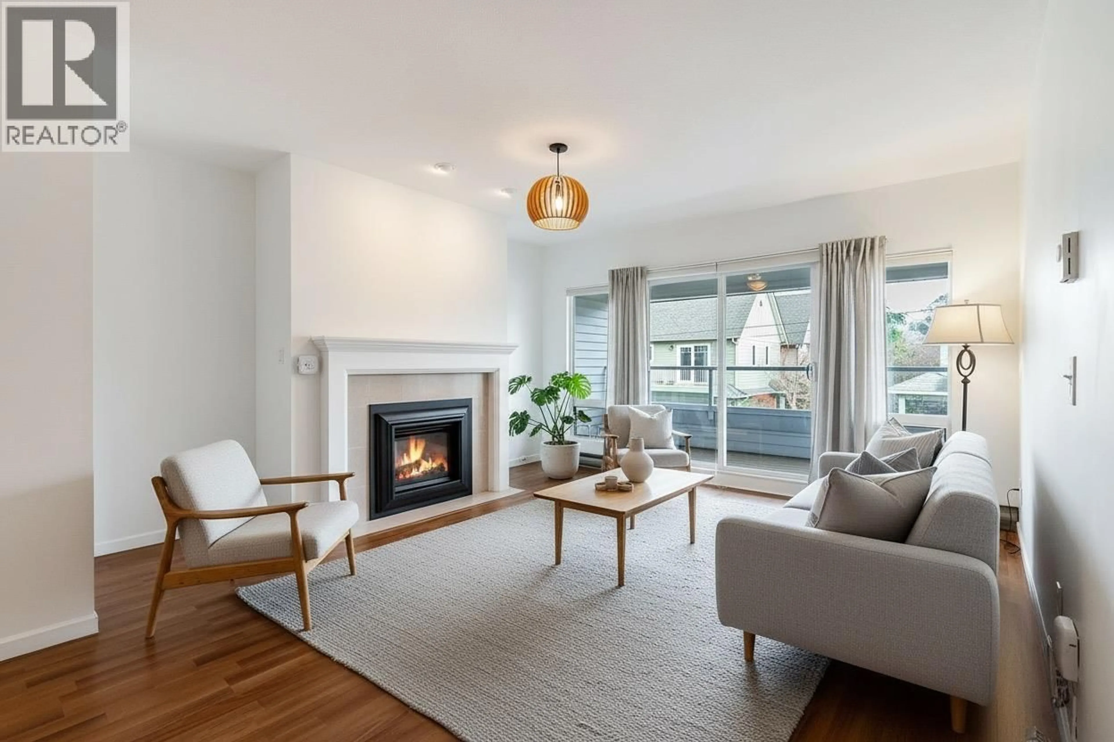 Living room with furniture, wood/laminate floor for 208 - 4989 47 AVENUE, Delta British Columbia V4K1R1