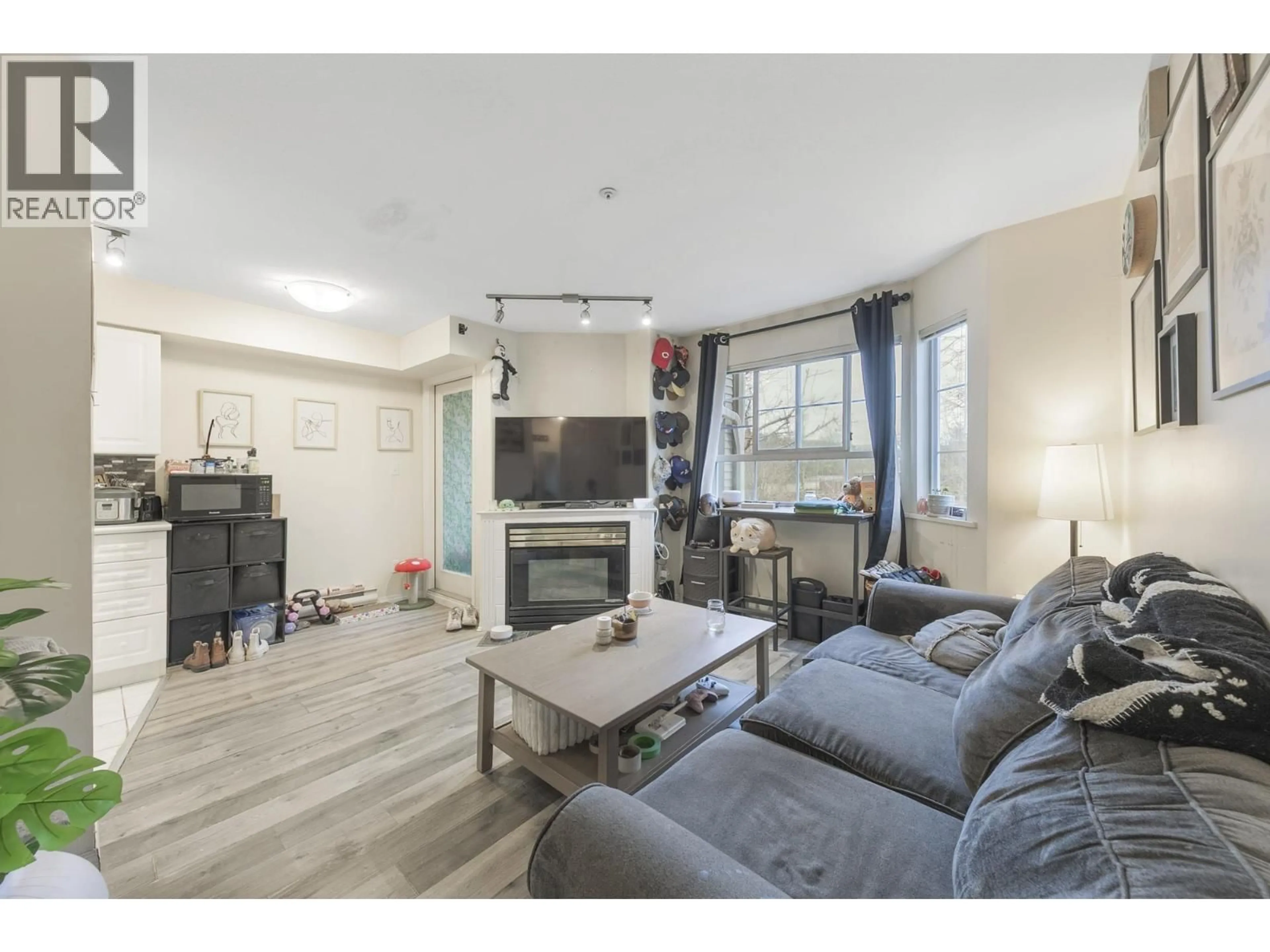 Living room with furniture, wood/laminate floor for 203 - 1520 COTTON DRIVE, Vancouver British Columbia V5L3V2