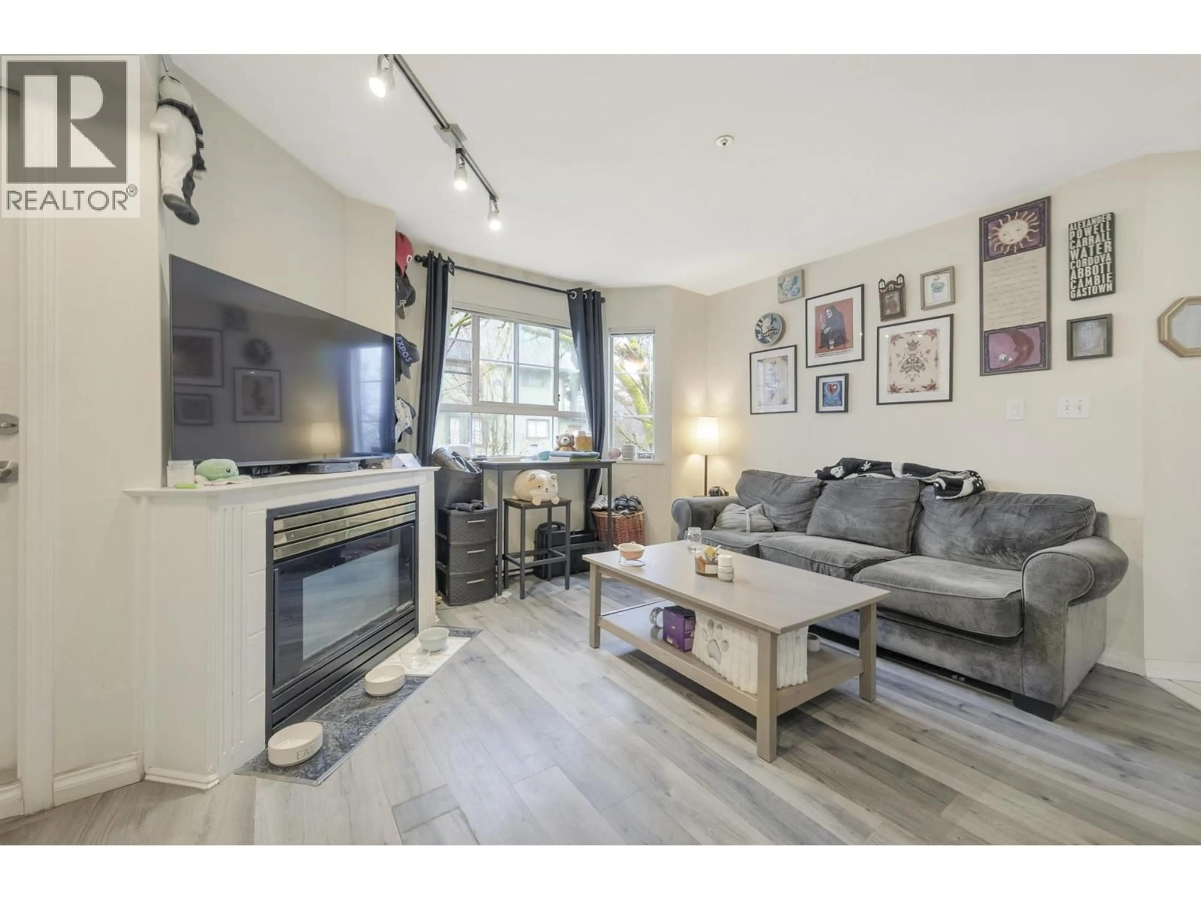 Living room with furniture, wood/laminate floor for 203 - 1520 COTTON DRIVE, Vancouver British Columbia V5L3V2