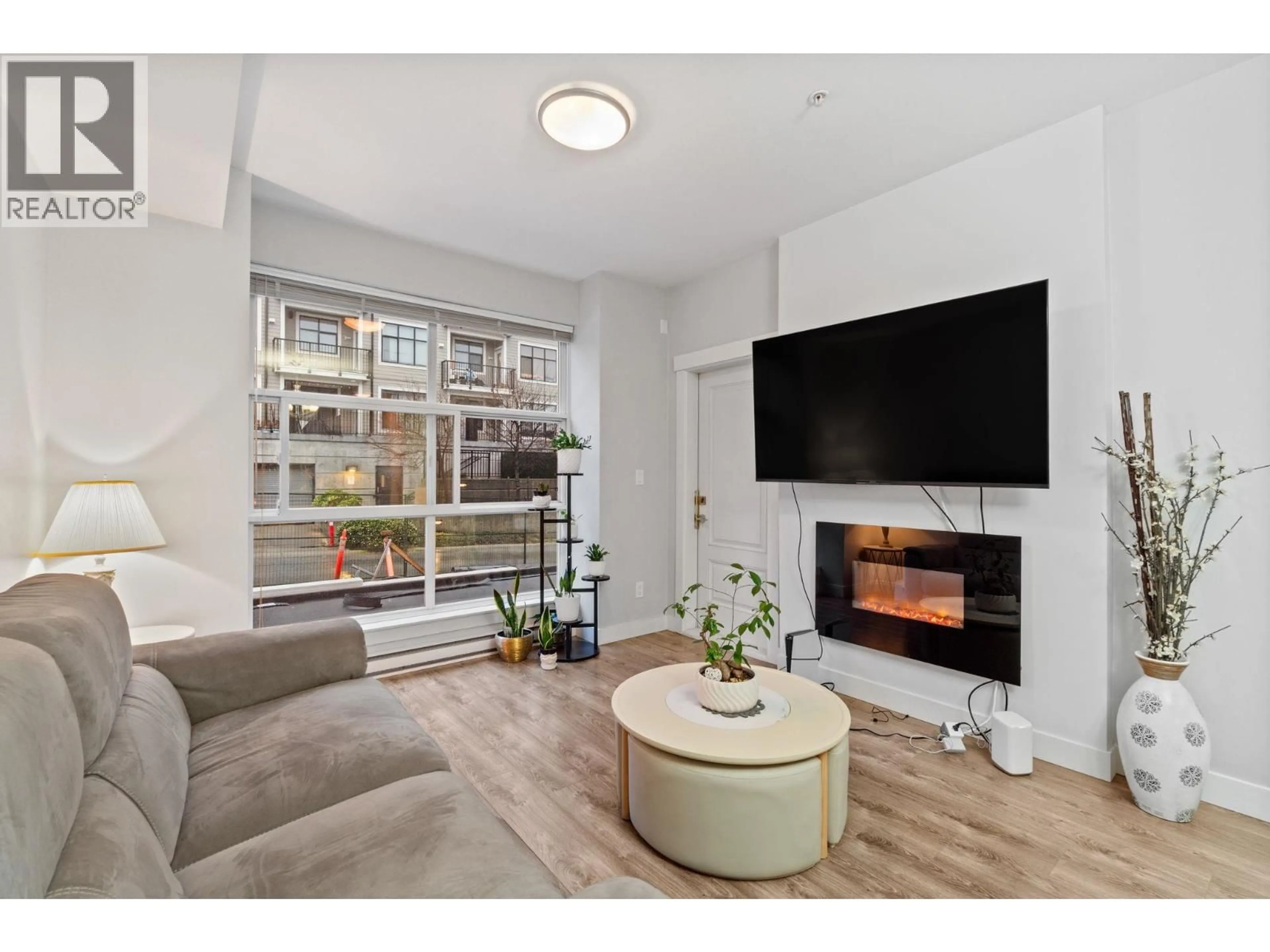 Living room with furniture, wood/laminate floor for 208 - 827 RODERICK AVENUE, Coquitlam British Columbia V3K0E3