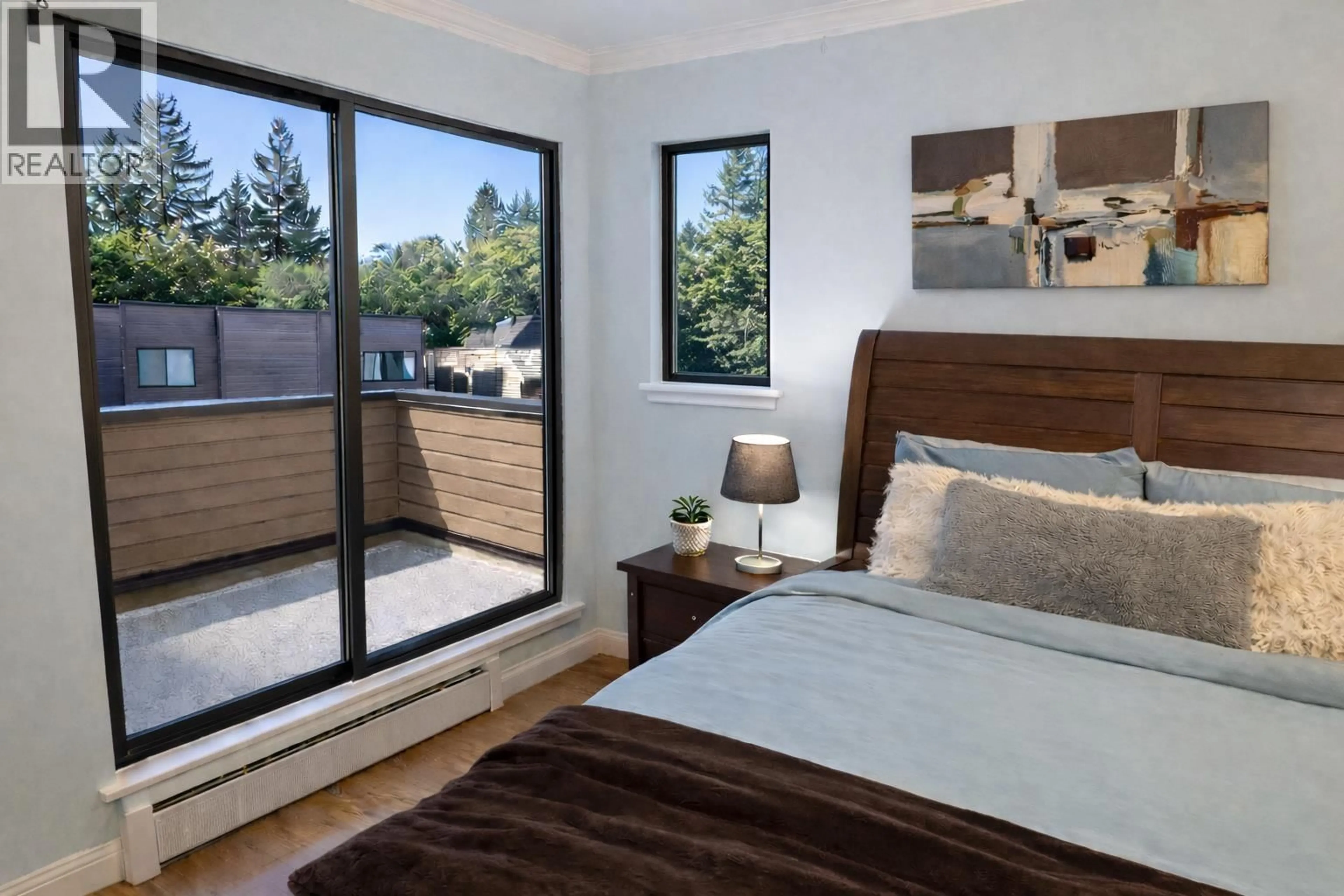 Bedroom with bed, wood/laminate floor for 307 - 3275 MOUNTAIN HIGHWAY, North Vancouver British Columbia V7K2H4