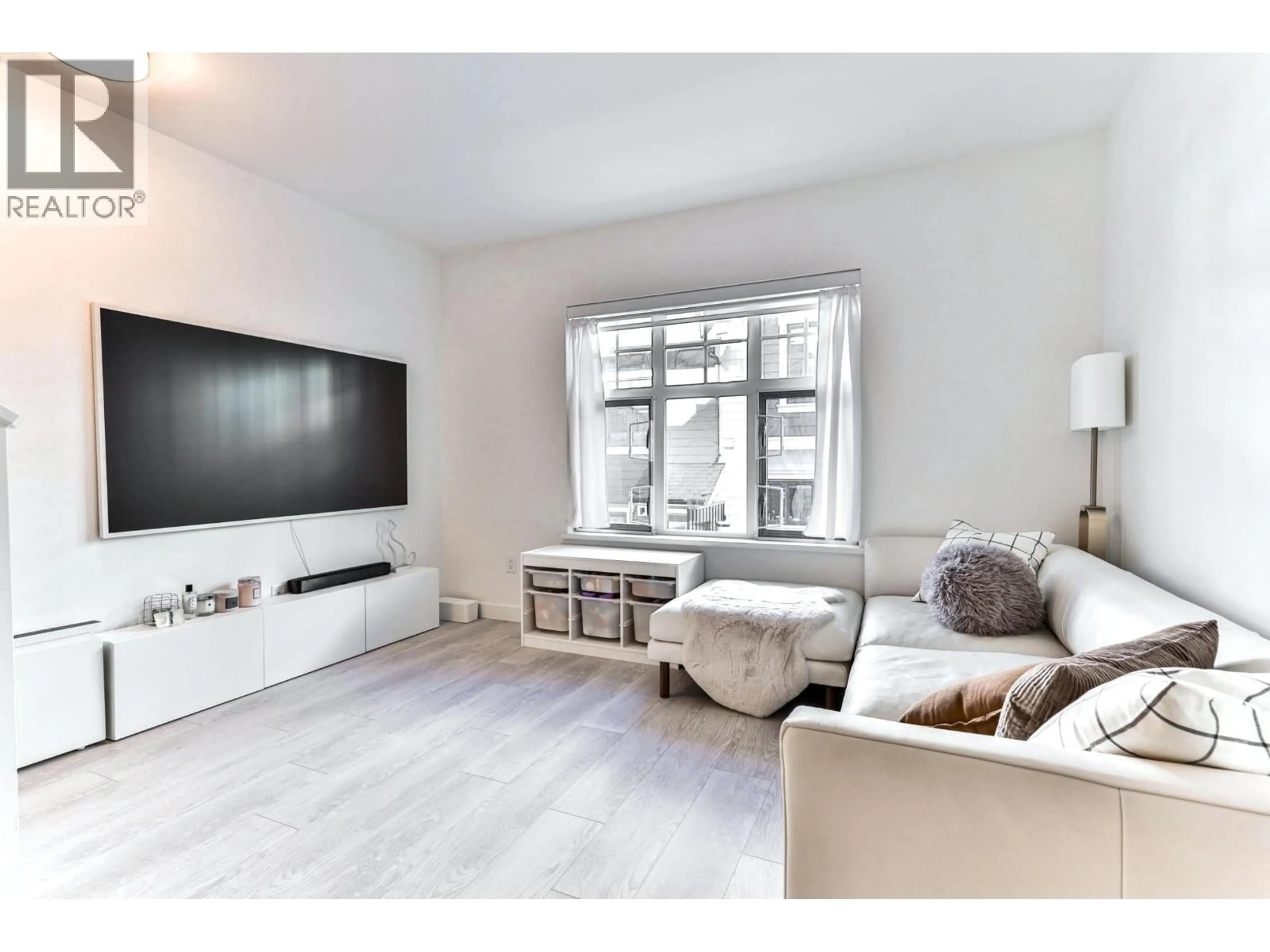 Living room with furniture, wood/laminate floor for 204 - 678 FAIRVIEW STREET, Coquitlam British Columbia V3J0N1