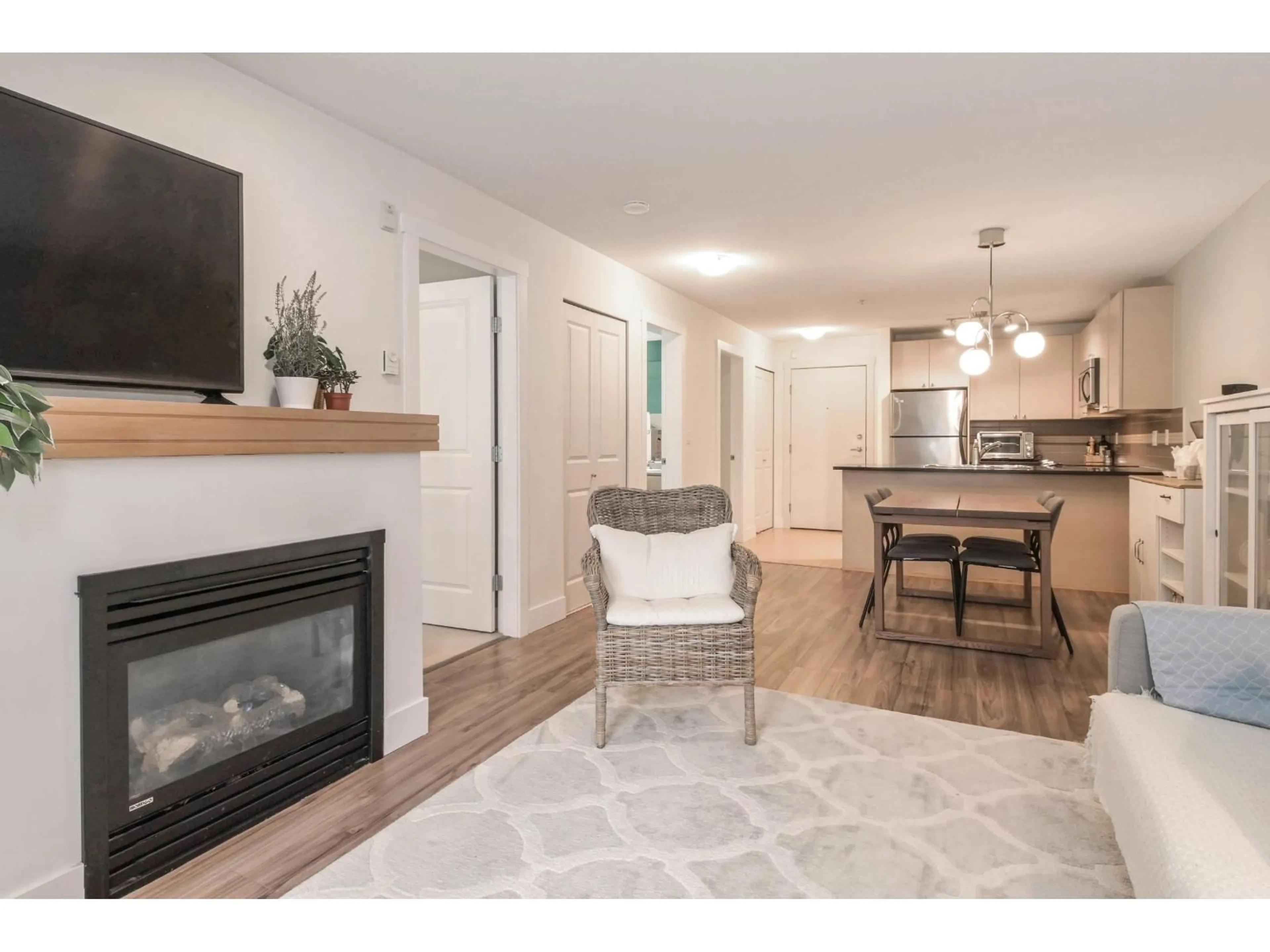 Living room with furniture, wood/laminate floor for 205 - 6500 194 STREET, Surrey British Columbia V4N5X4