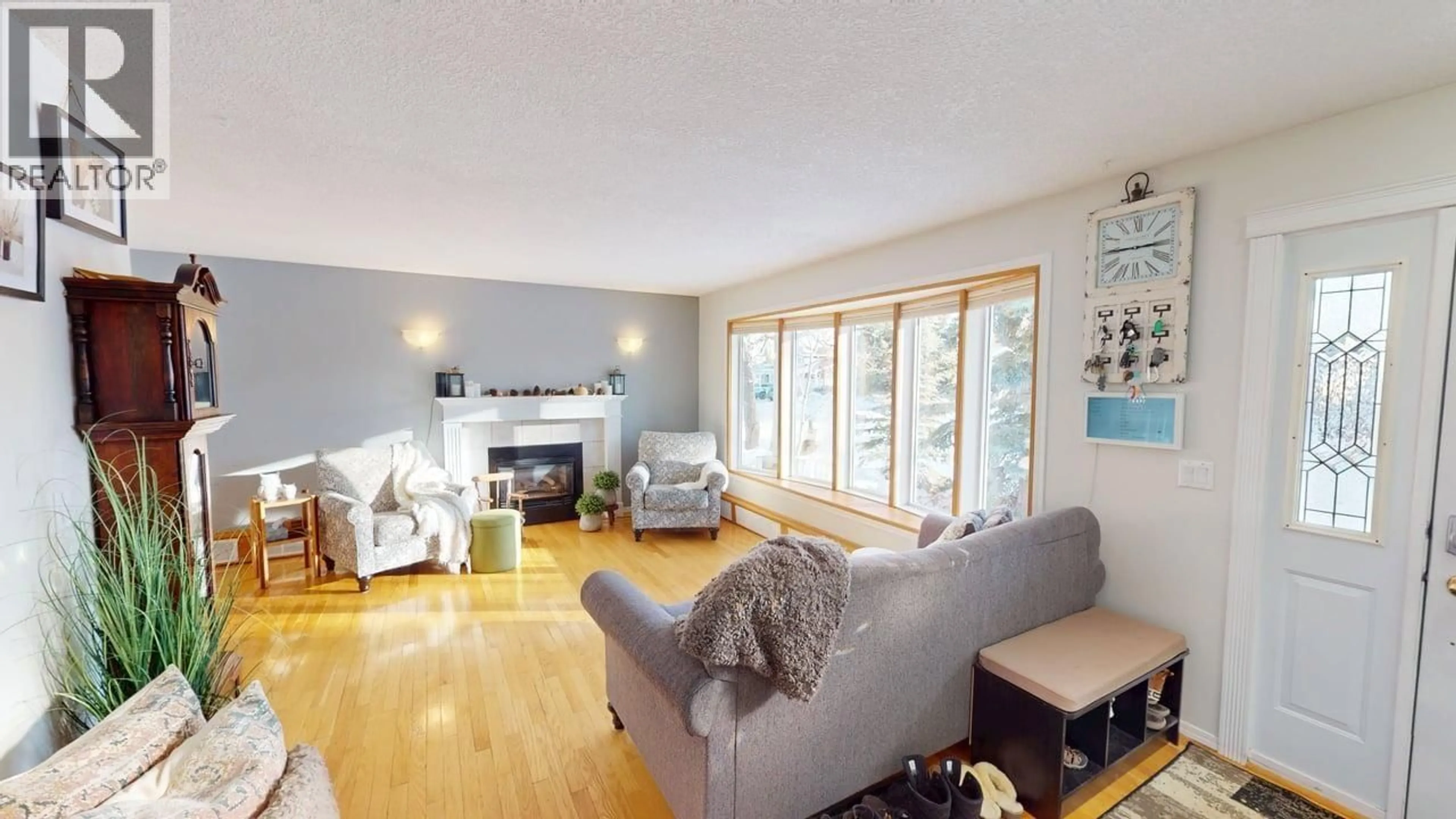 Living room with furniture, wood/laminate floor for 9420 105 AVENUE, Fort St. John British Columbia V1J4V7