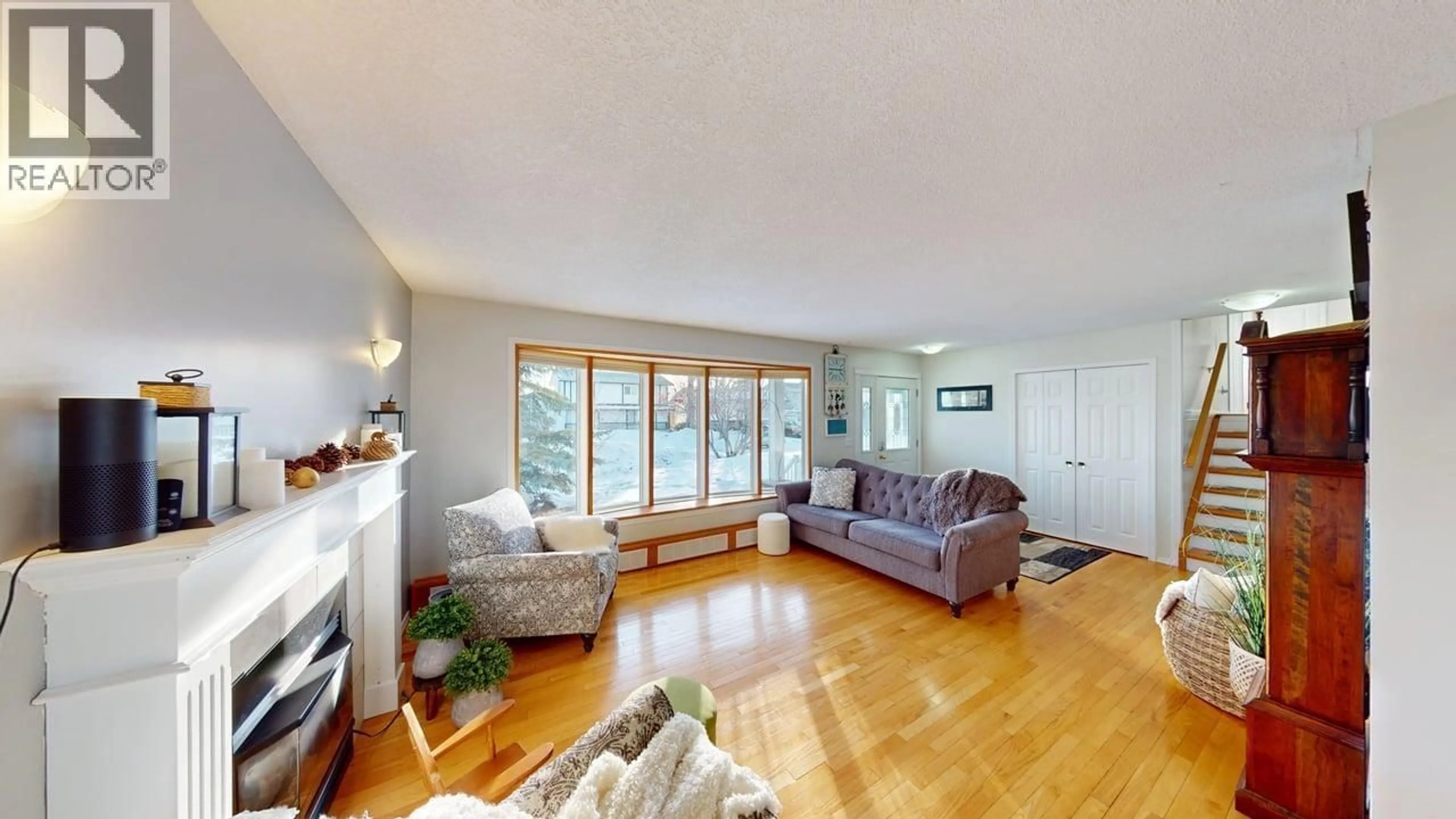 Living room with furniture, wood/laminate floor for 9420 105 AVENUE, Fort St. John British Columbia V1J4V7