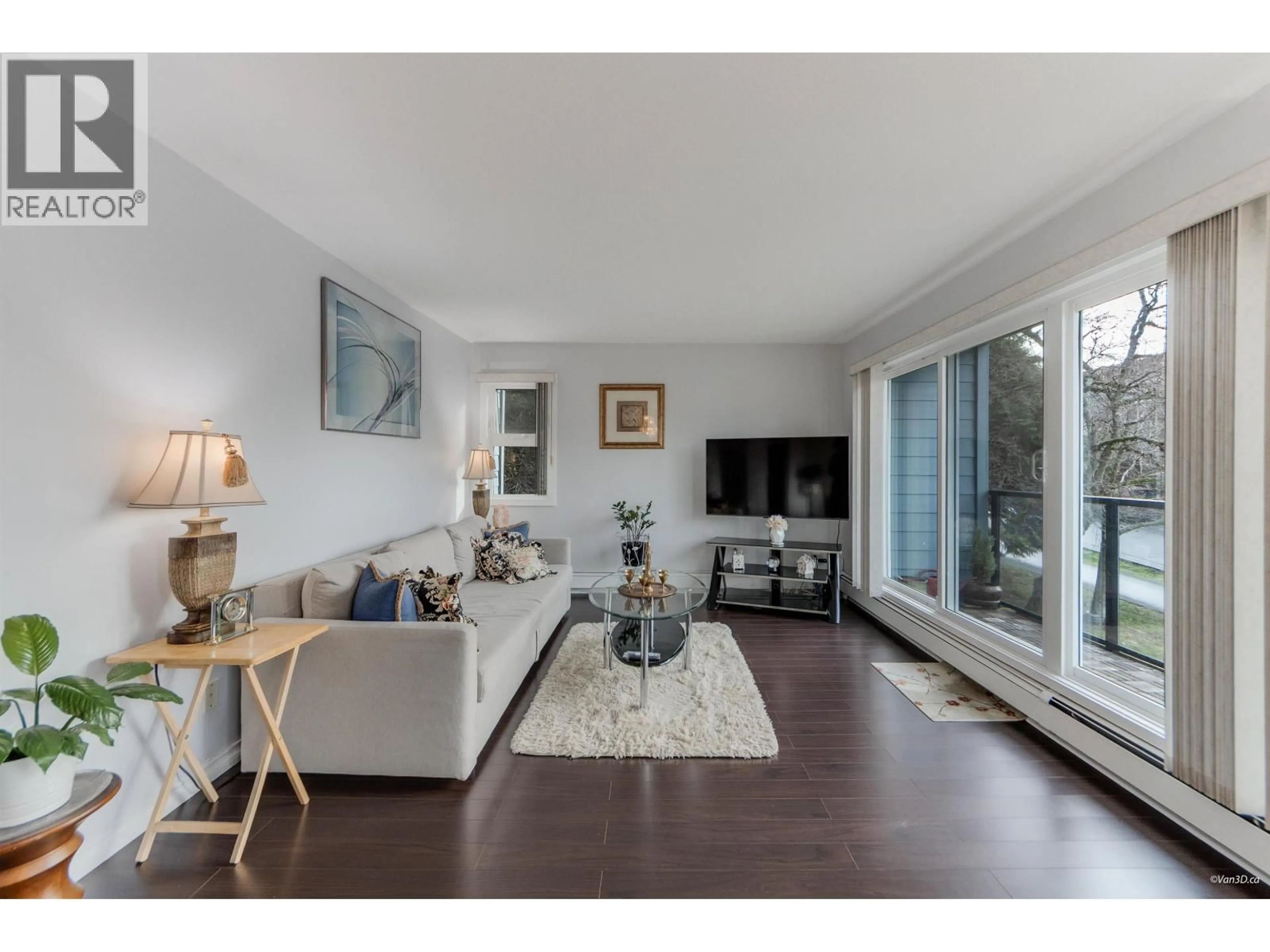 Living room with furniture, wood/laminate floor for 208 - 156 21ST STREET, North Vancouver British Columbia V7M1Y9