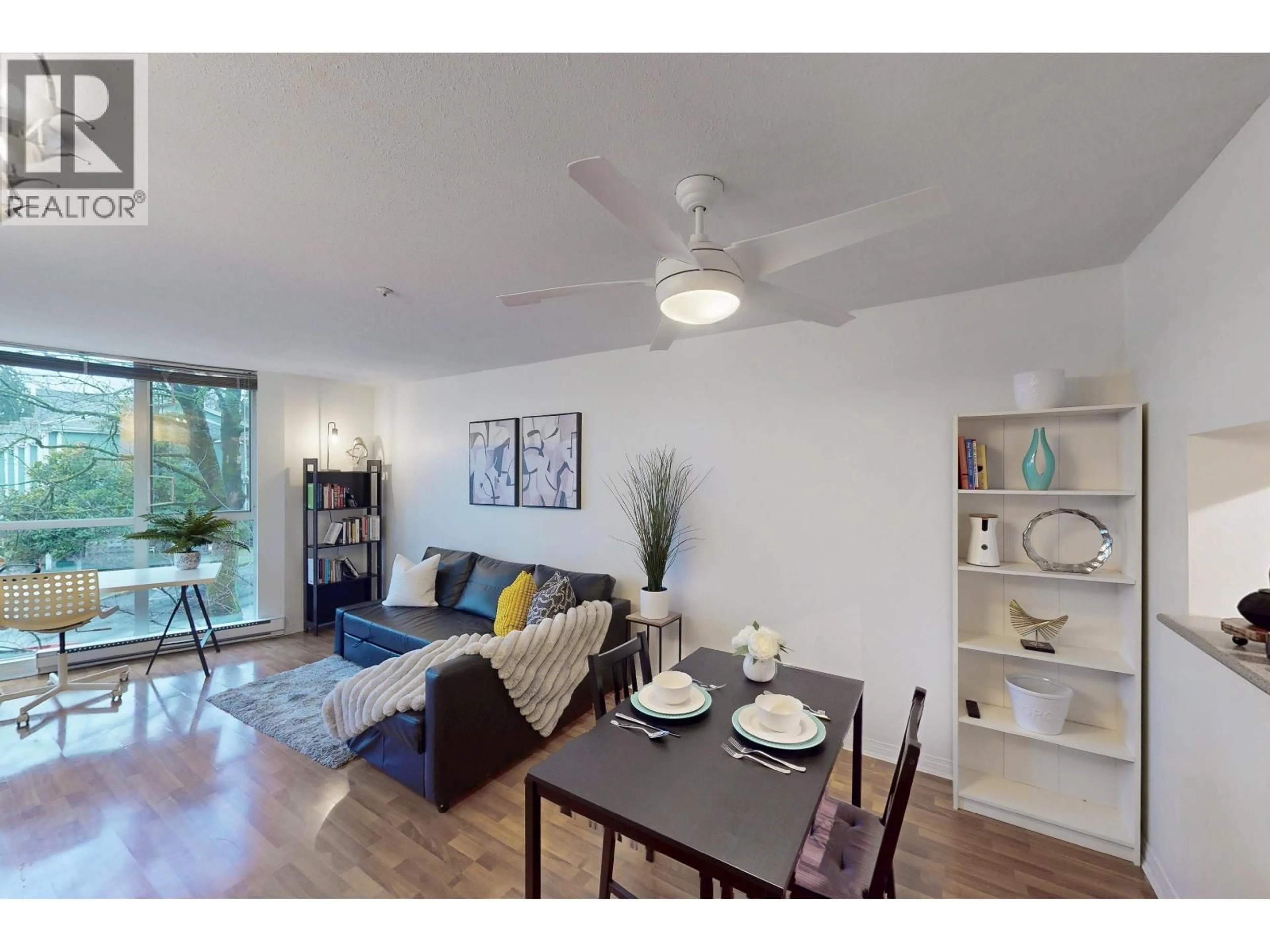 Living room with furniture, wood/laminate floor for 302 - 8420 JELLICOE STREET, Vancouver British Columbia V5S4T1