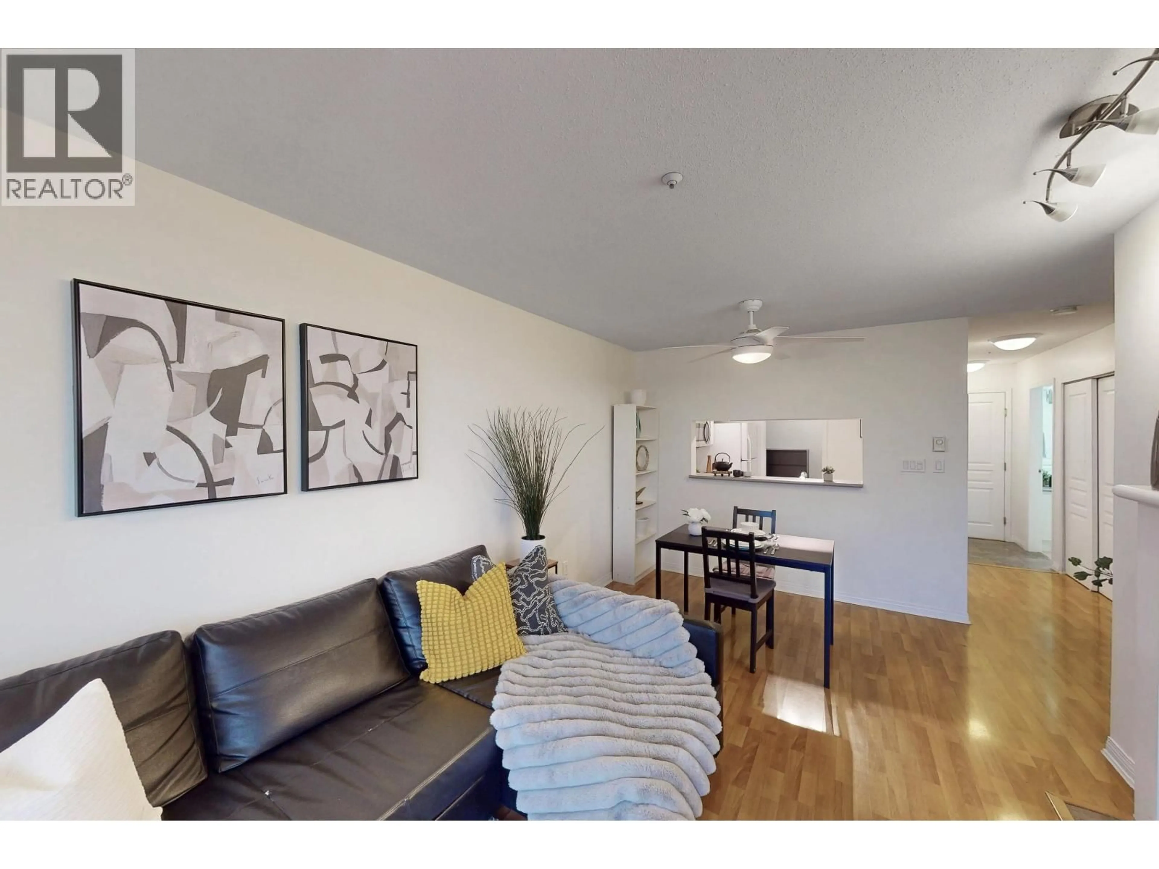 Living room with furniture, wood/laminate floor for 302 - 8420 JELLICOE STREET, Vancouver British Columbia V5S4T1