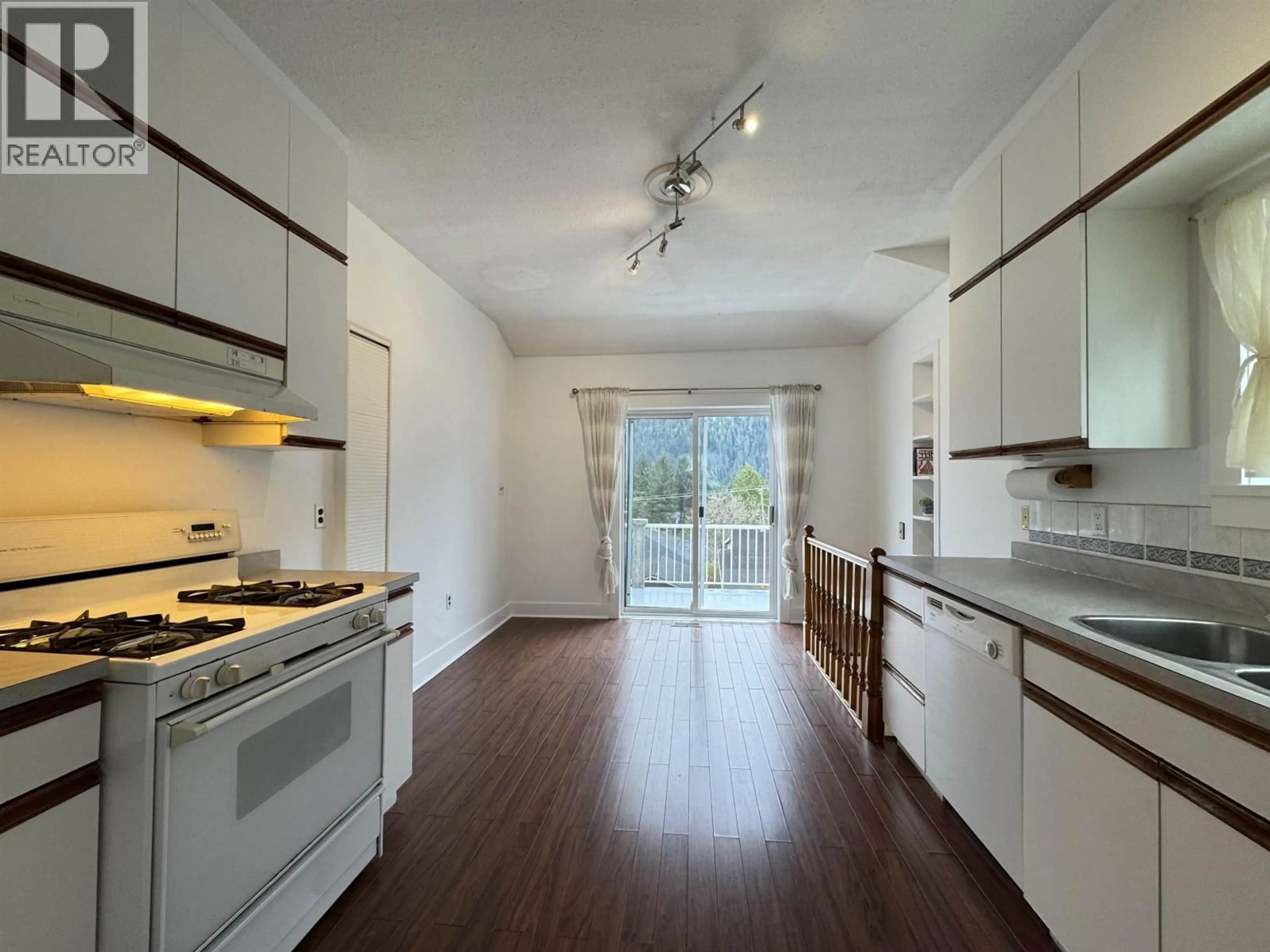 Open concept kitchen, wood/laminate floor for 723 6TH AVENUE, Prince Rupert British Columbia V8J1Z8