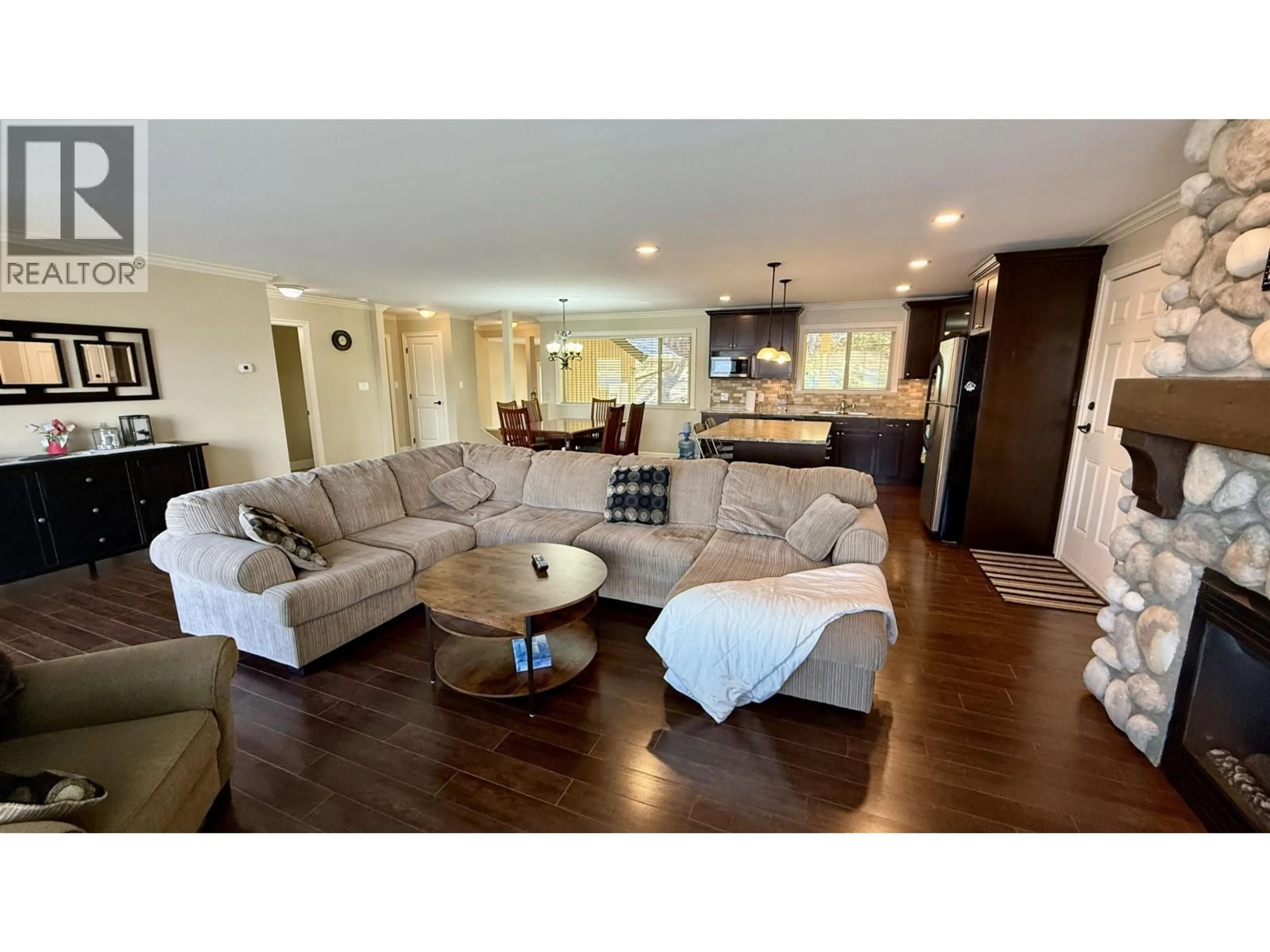 Living room with furniture, wood/laminate floor for 4635 CAVERLY ROAD, Lac La Hache British Columbia V0K1T0