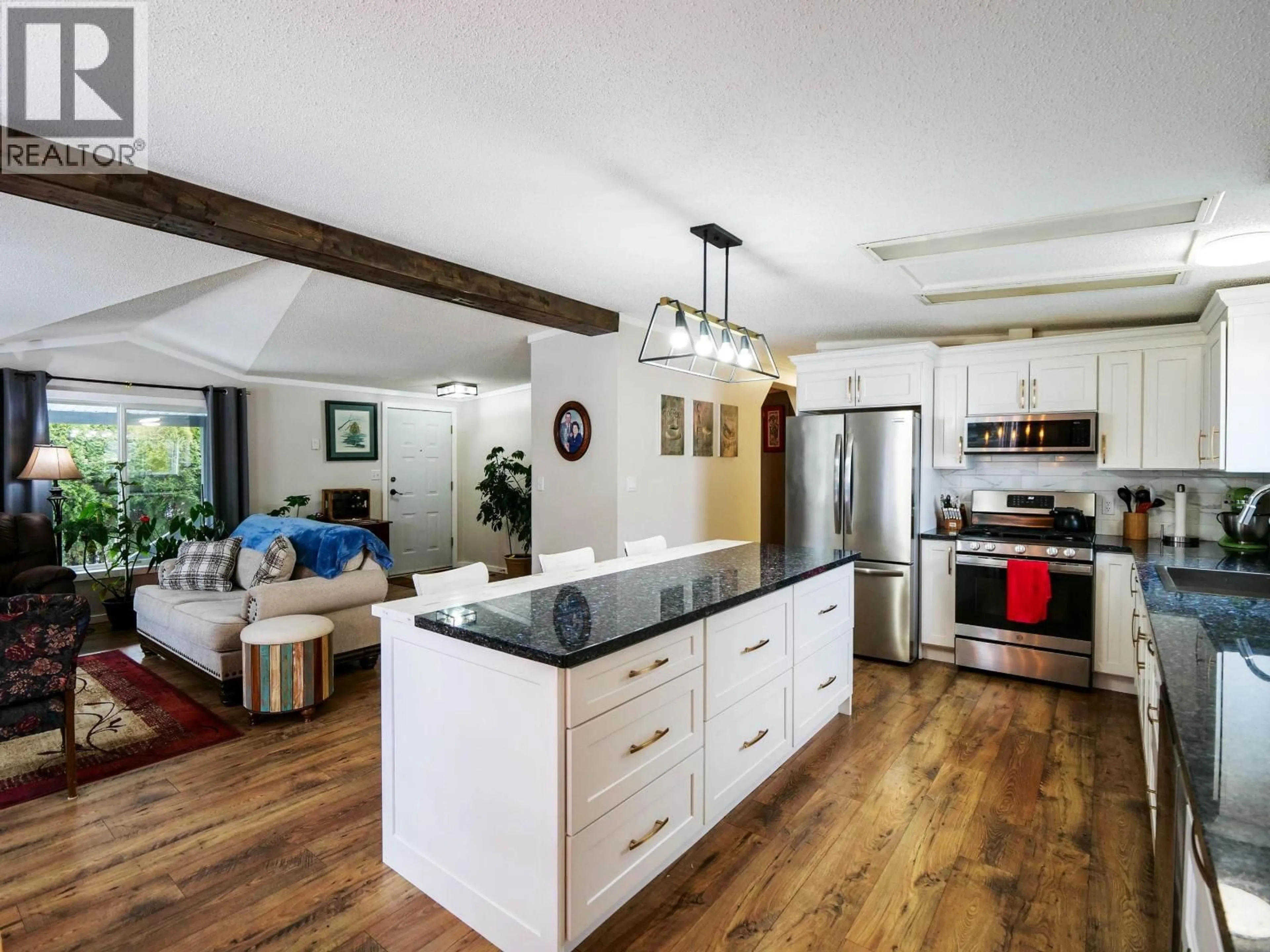 Open concept kitchen, wood/laminate floor for 831 KUBE STREET, Quesnel British Columbia V2J5P9