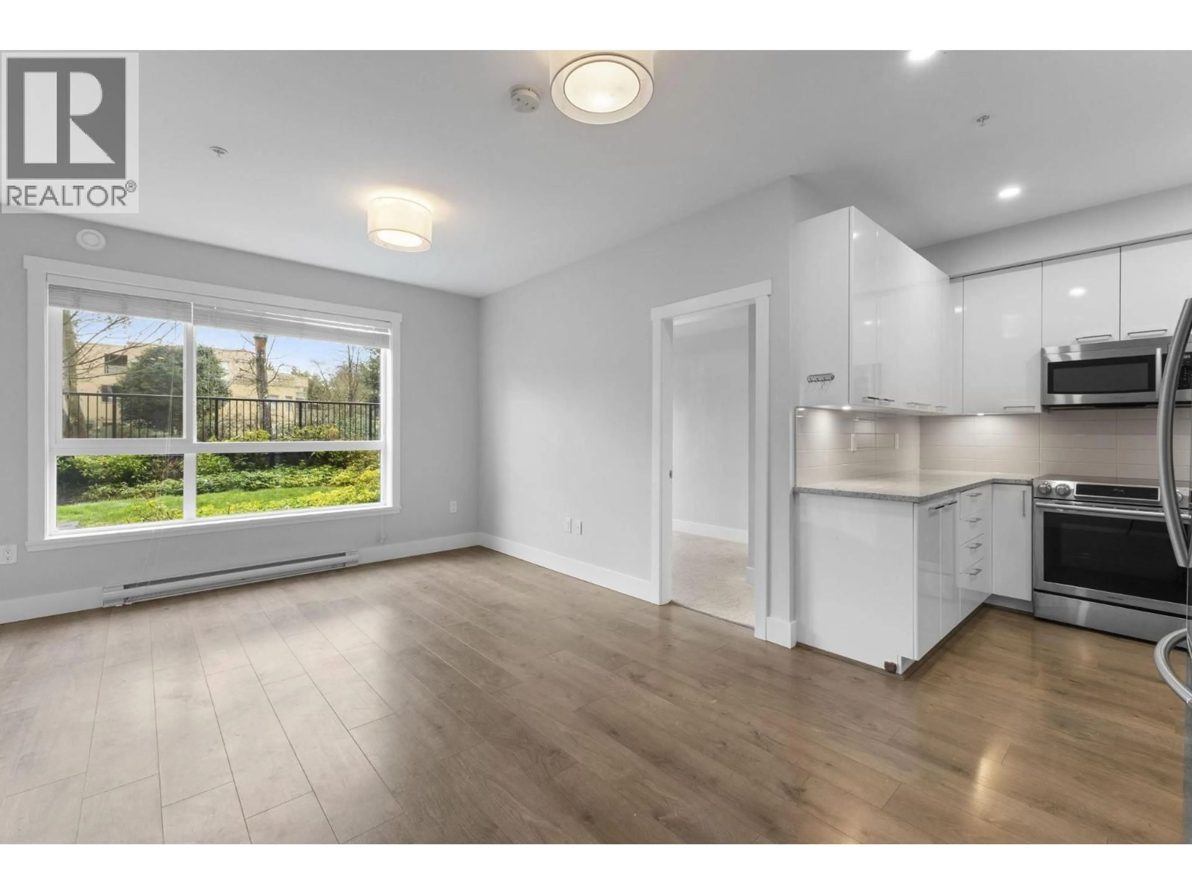 Open concept kitchen, wood/laminate floor for 106 - 22315 122 AVENUE, Maple Ridge British Columbia V2X4K7