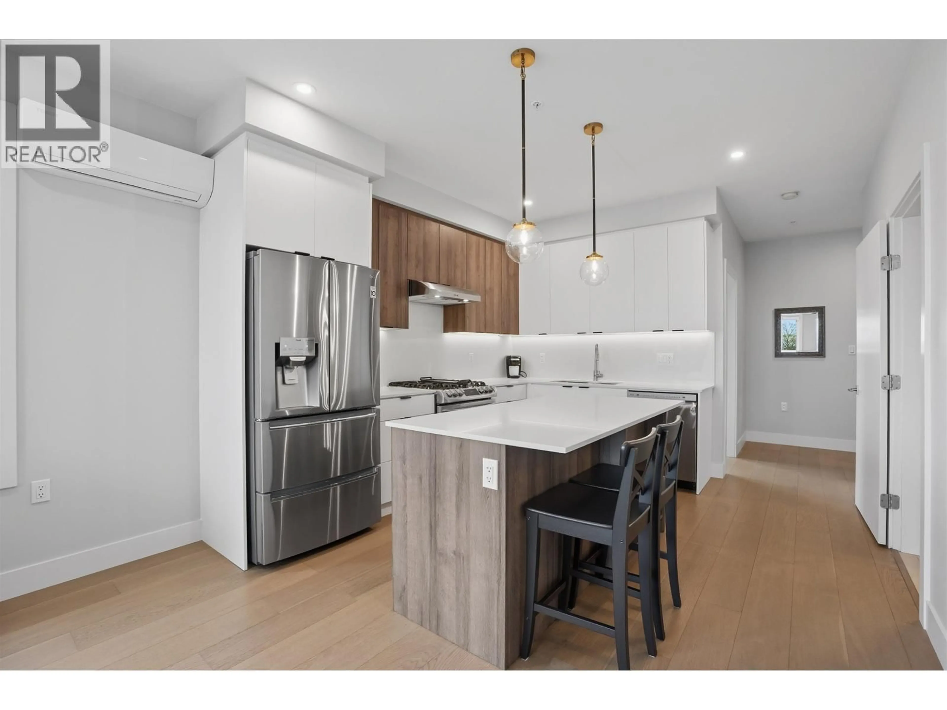 Open concept kitchen, wood/laminate floor for 301 - 4686 51 STREET, Delta British Columbia V4K0E5