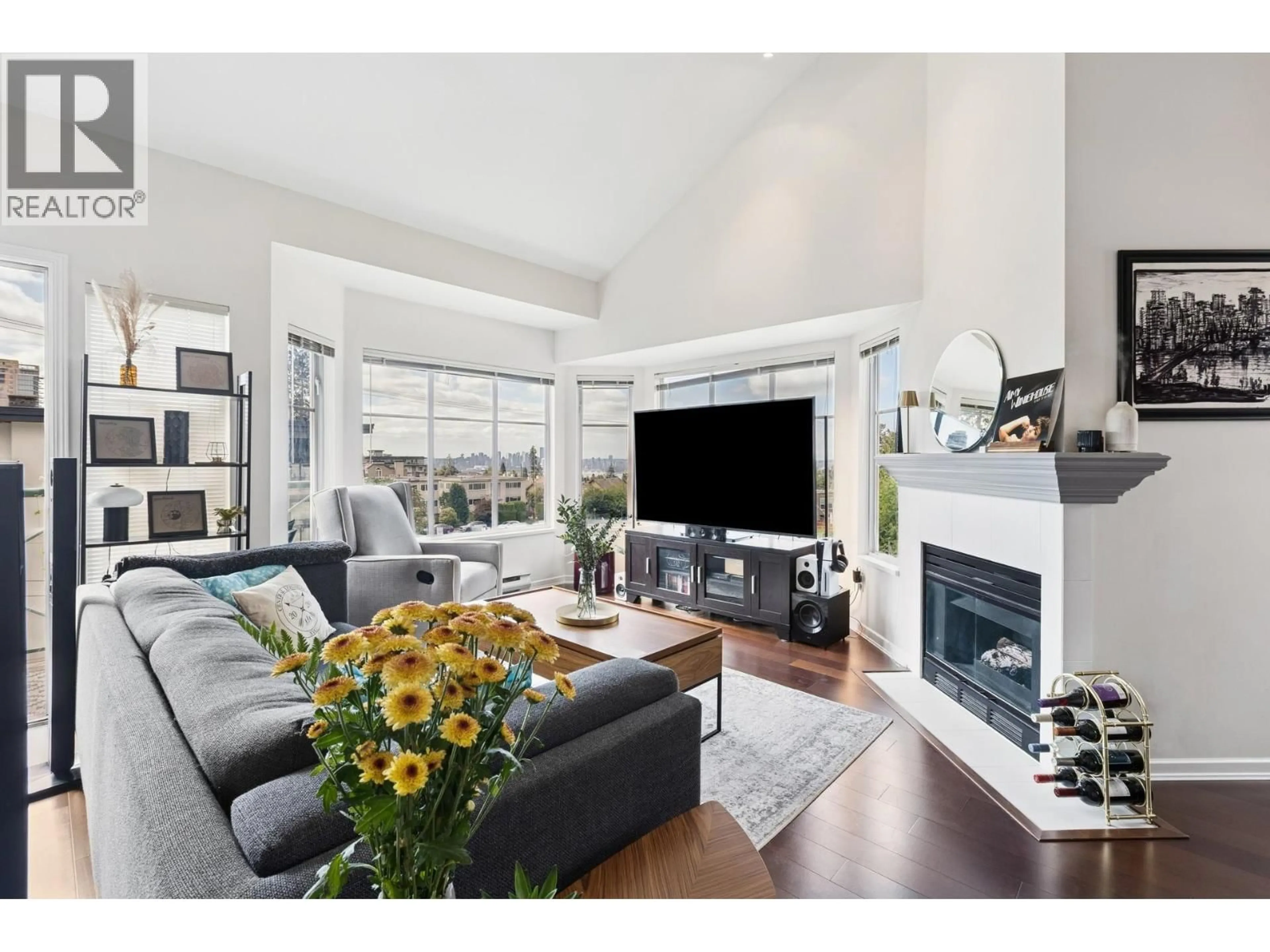 Living room with furniture, wood/laminate floor for 303 - 131 20TH STREET, North Vancouver British Columbia V7M1Y2