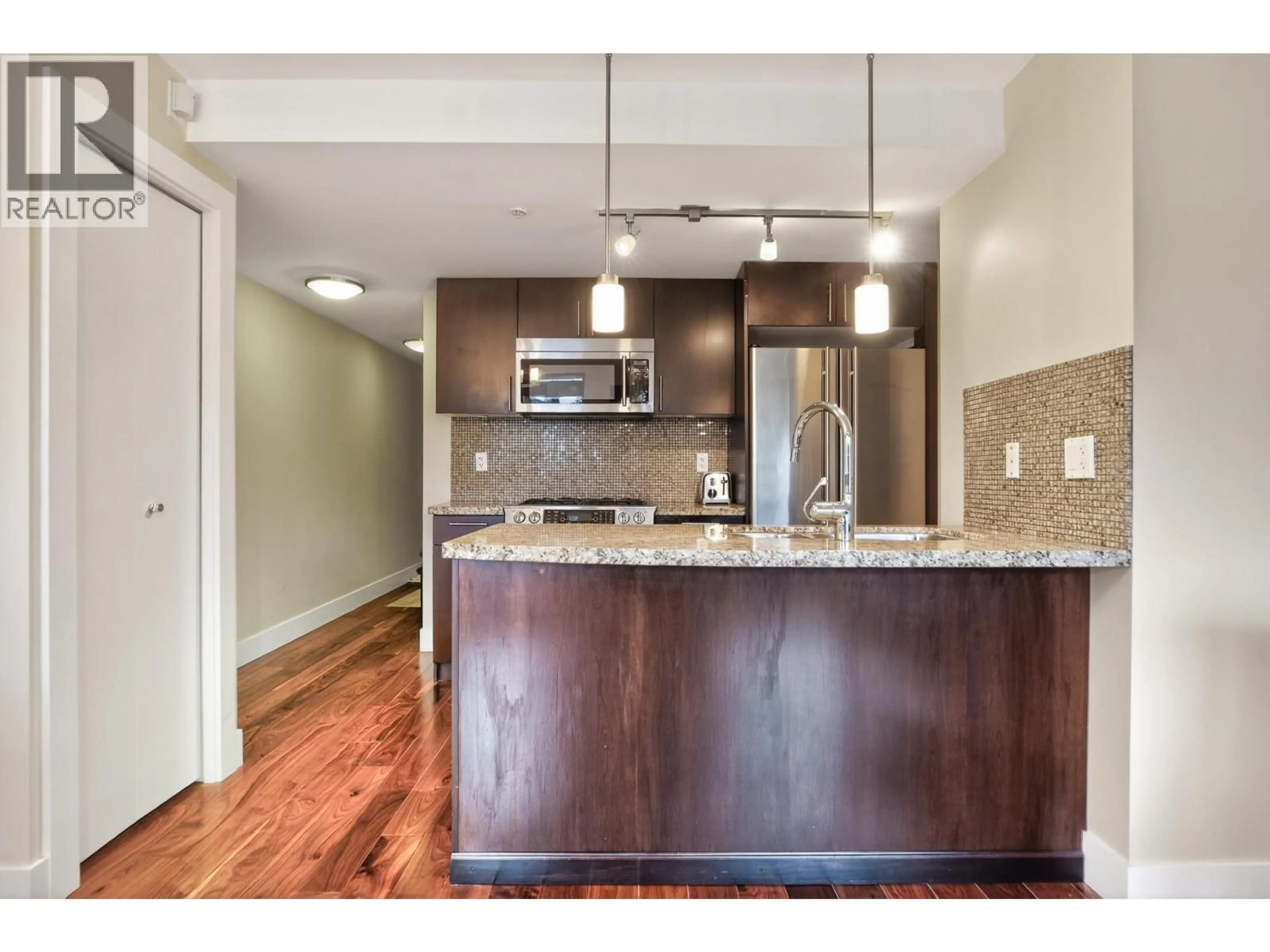 Open concept kitchen, wood/laminate floor for 401 - 3611 18TH AVENUE, Vancouver British Columbia V6S1B3