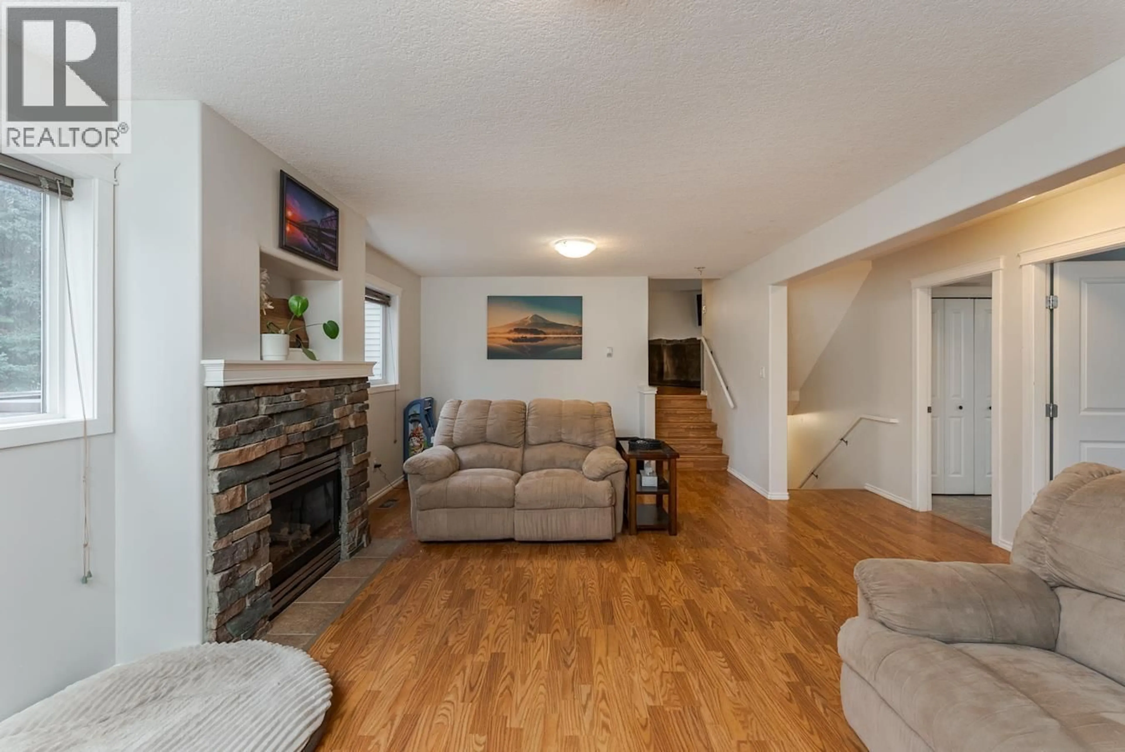 Living room with furniture, wood/laminate floor for 8311 FLAMINGO ROAD, Prince George British Columbia V2K5H2