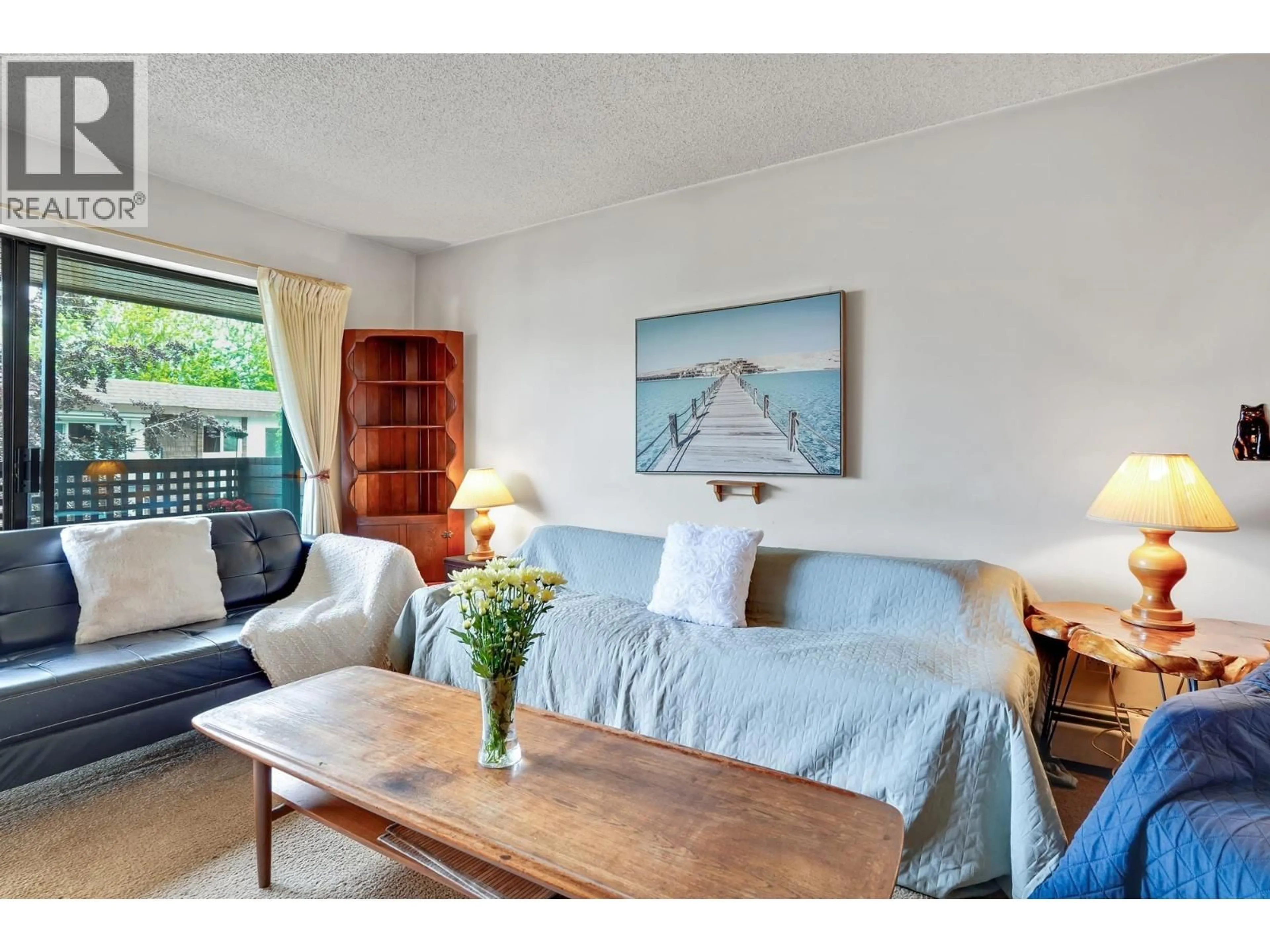 Living room with furniture, wood/laminate floor for 402 - 2215 DUNDAS STREET, Vancouver British Columbia V5L1J9