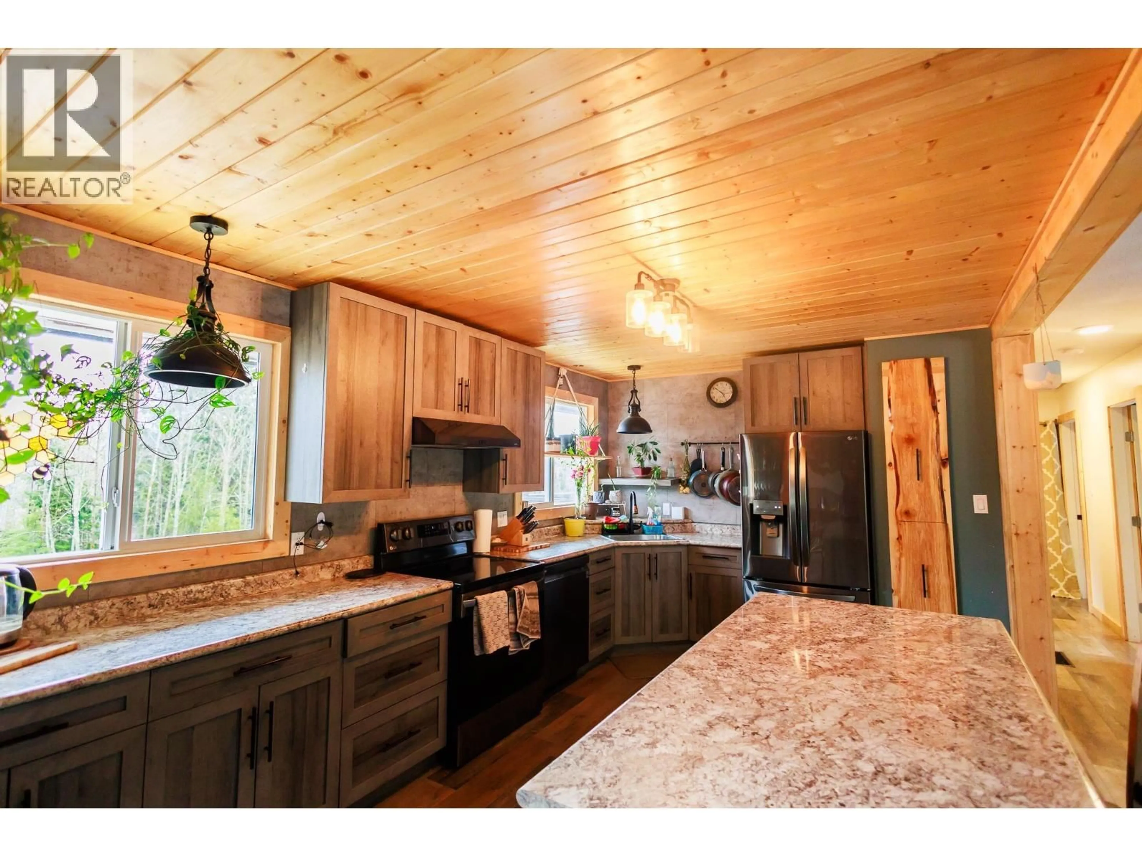 Open concept kitchen, wood/laminate floor for 5283 OLD REMO ROAD, Terrace British Columbia V8G0E3