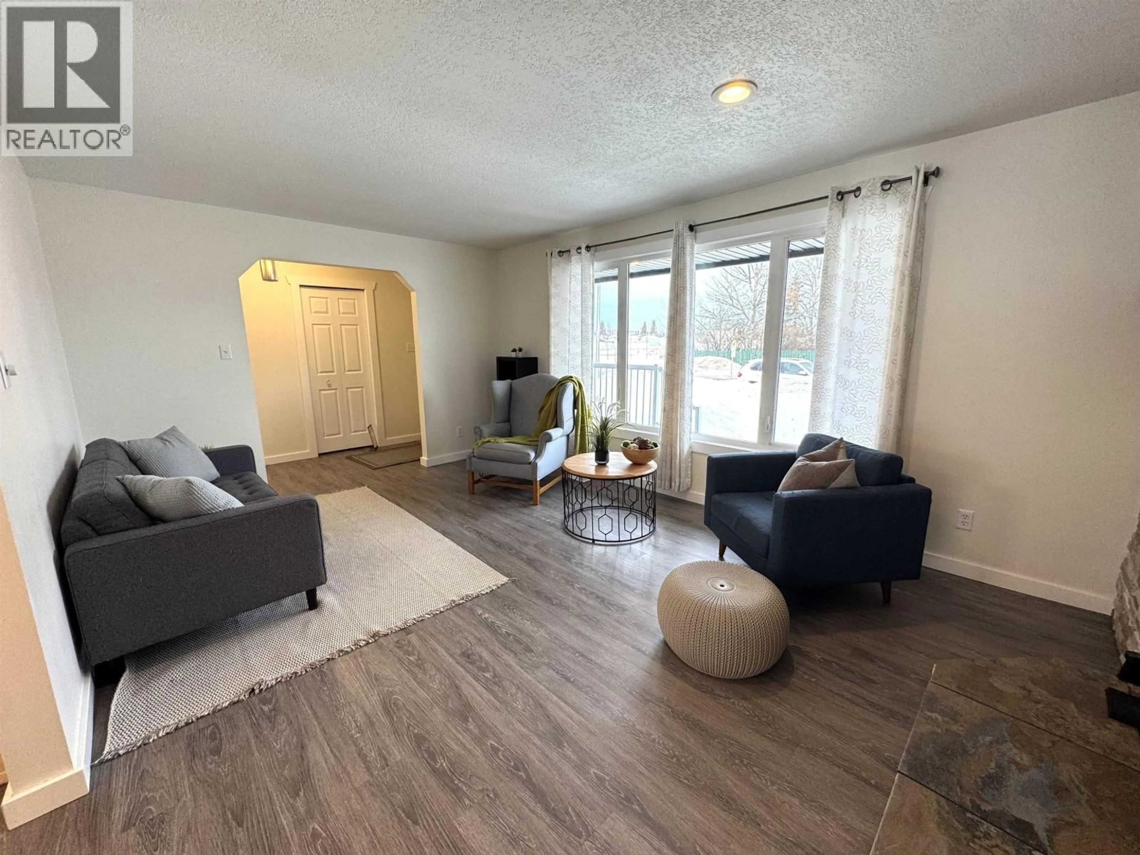 Living room with furniture, wood/laminate floor for 9407 106 AVENUE, Fort St. John British Columbia V1J5L4