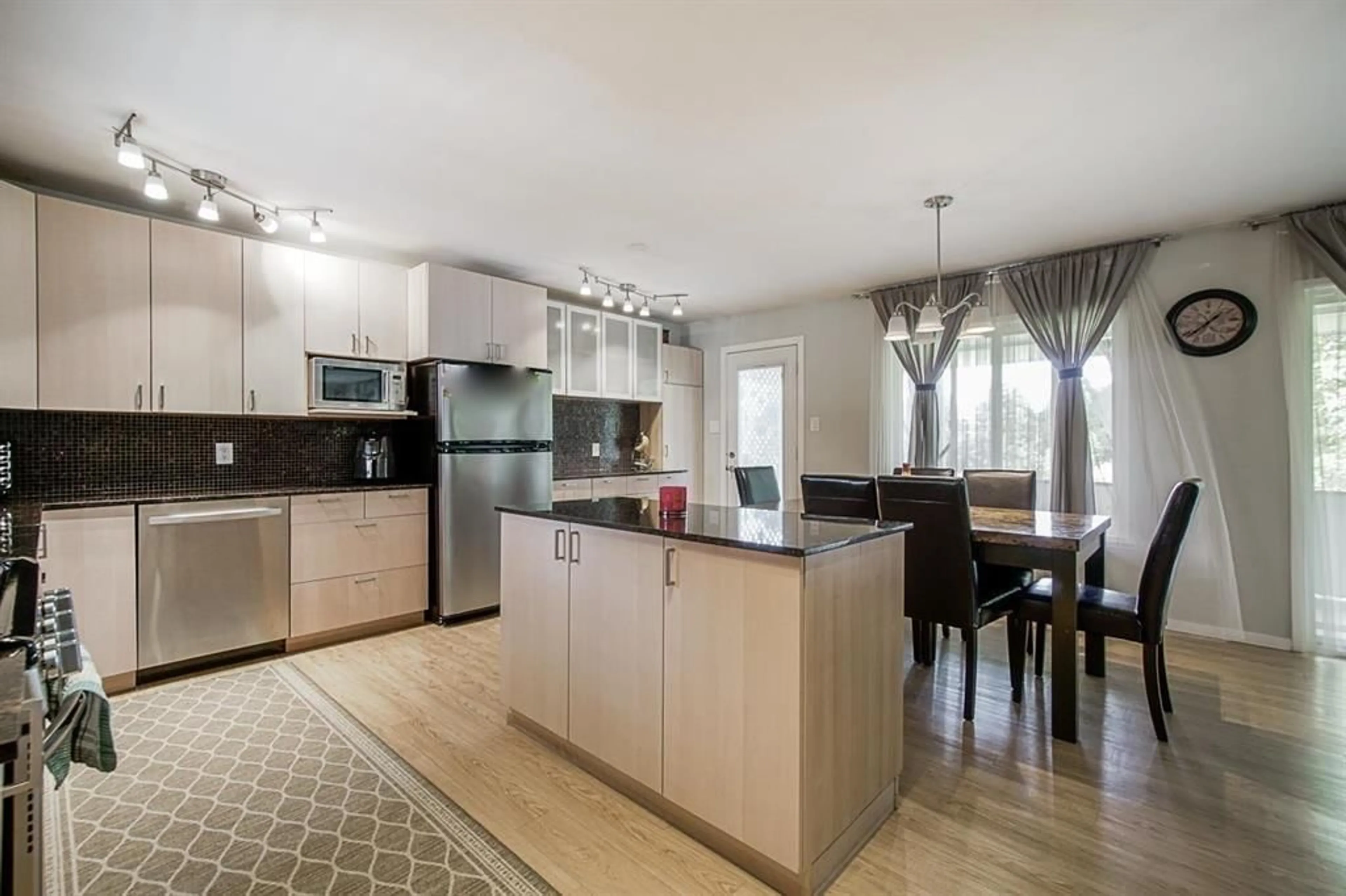 Open concept kitchen, wood/laminate floor for 11429 139A STREET, Surrey British Columbia V3R3E9